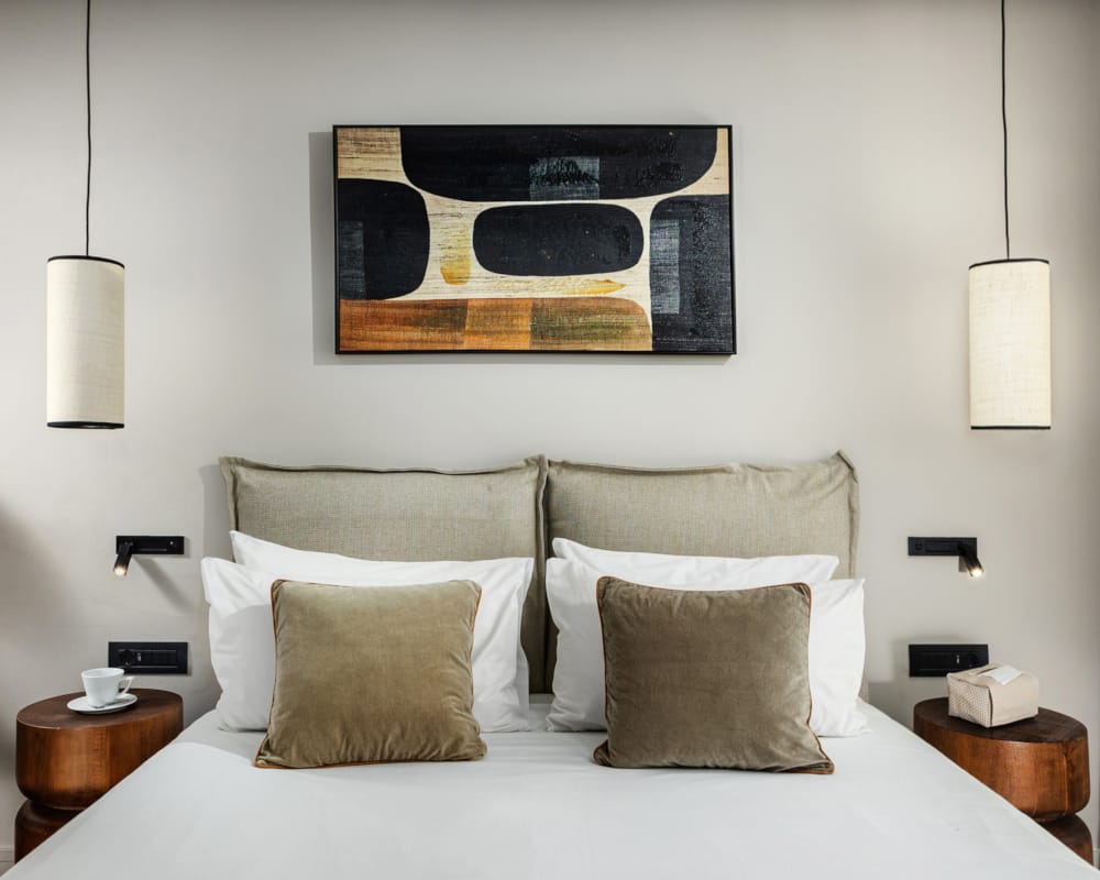 a bed with a picture on the wall