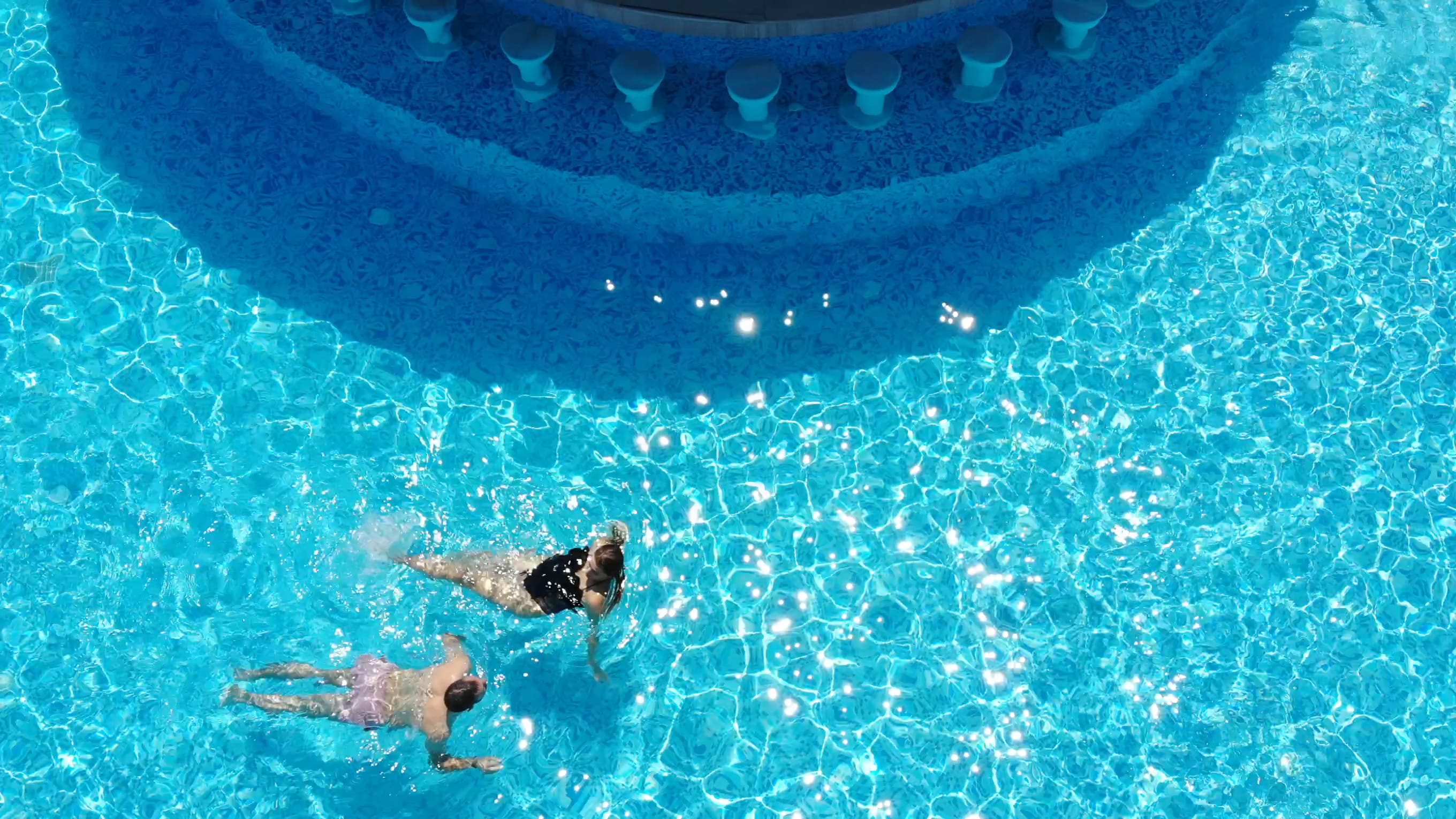 a group of people swimming in a pool