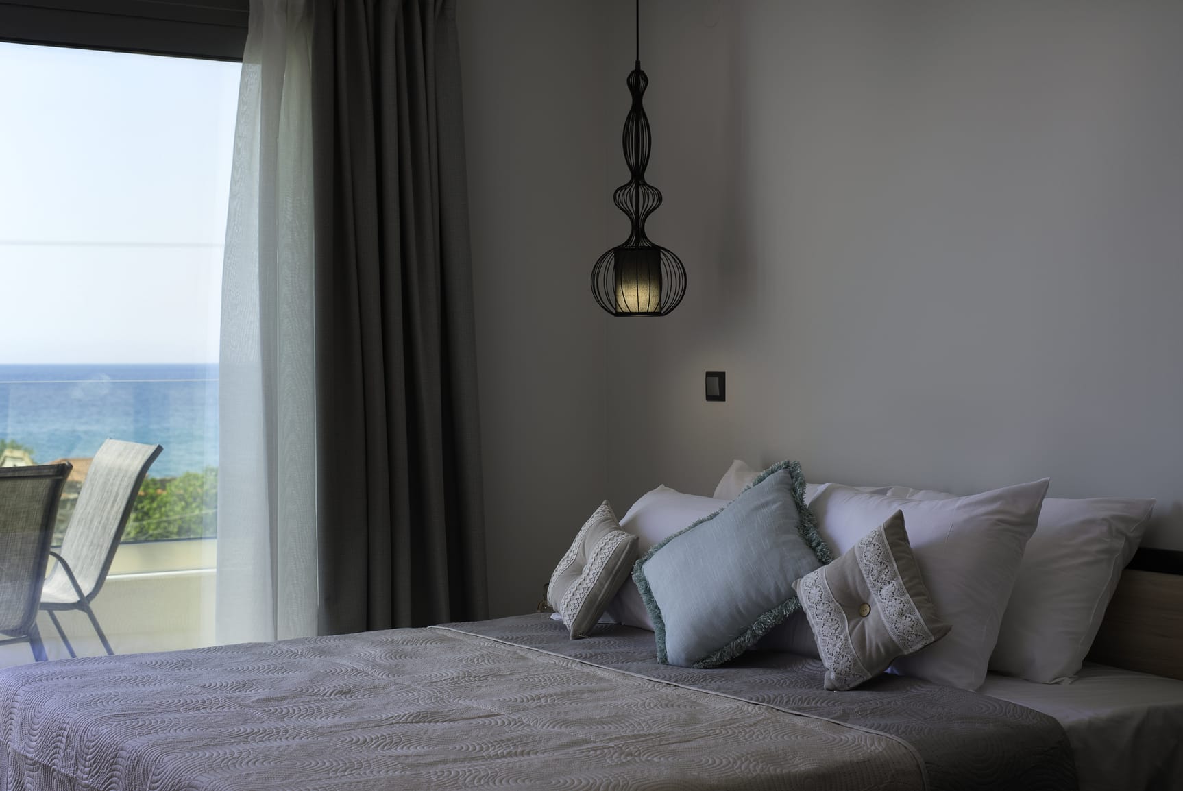 a bed with pillows and a lamp