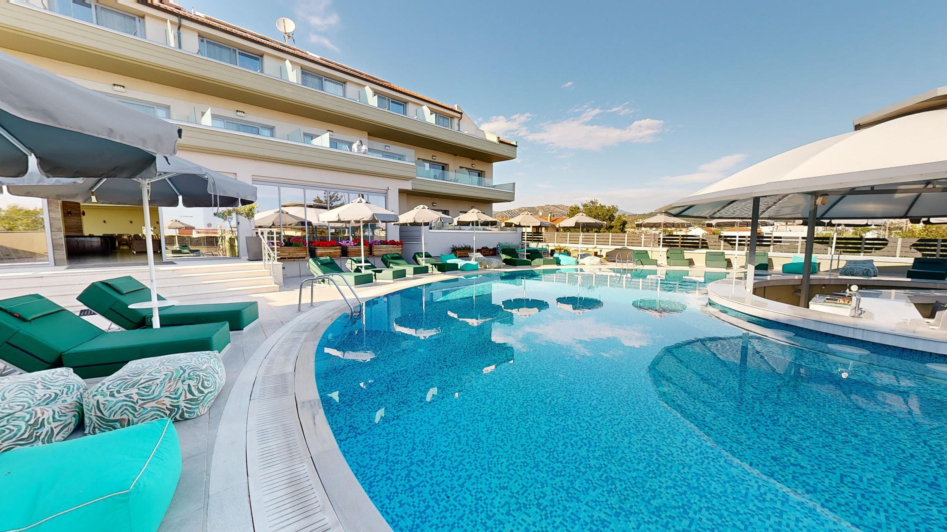 a swimming pool with lounge chairs
