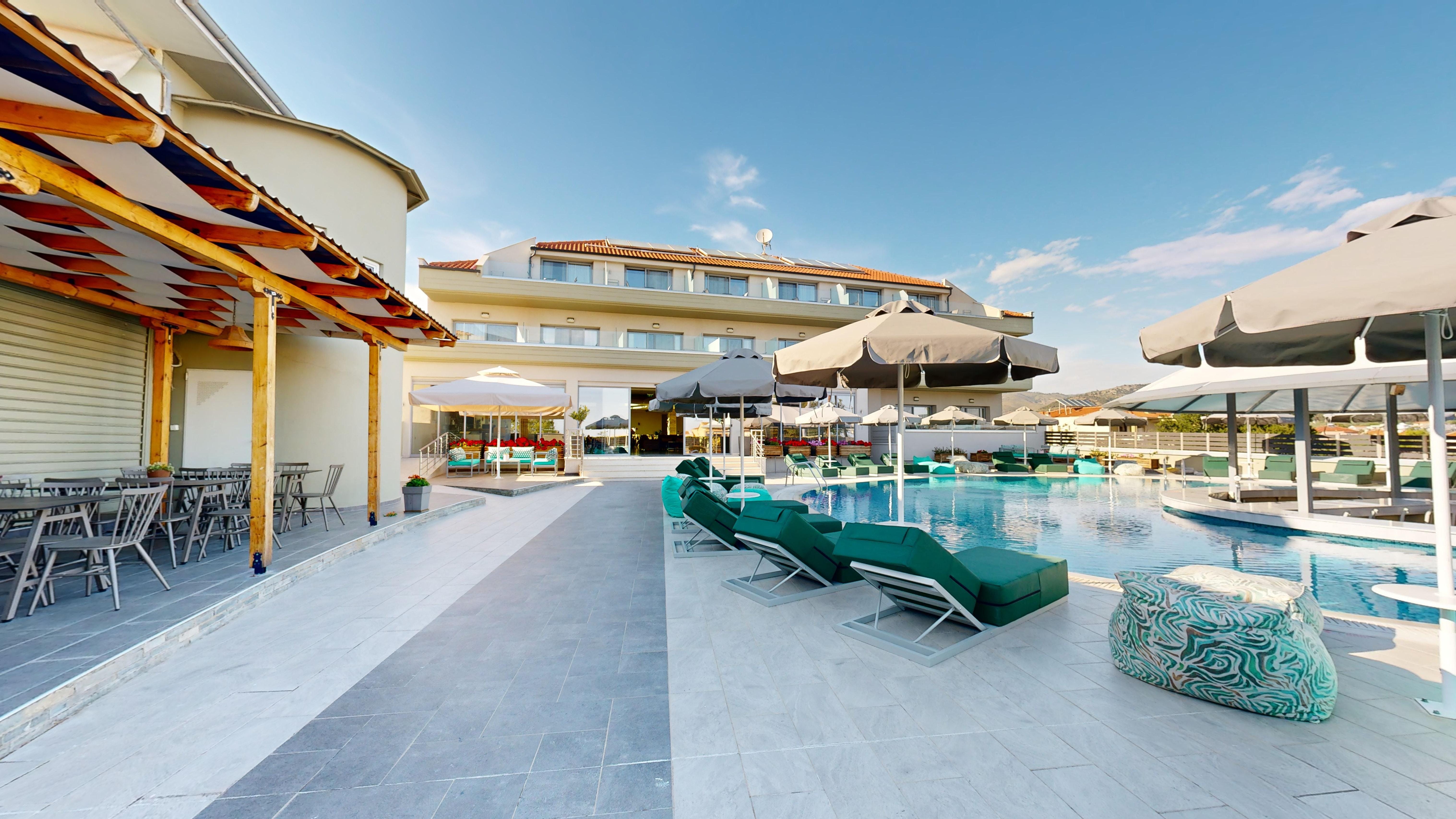 a pool with lounge chairs and umbrellas