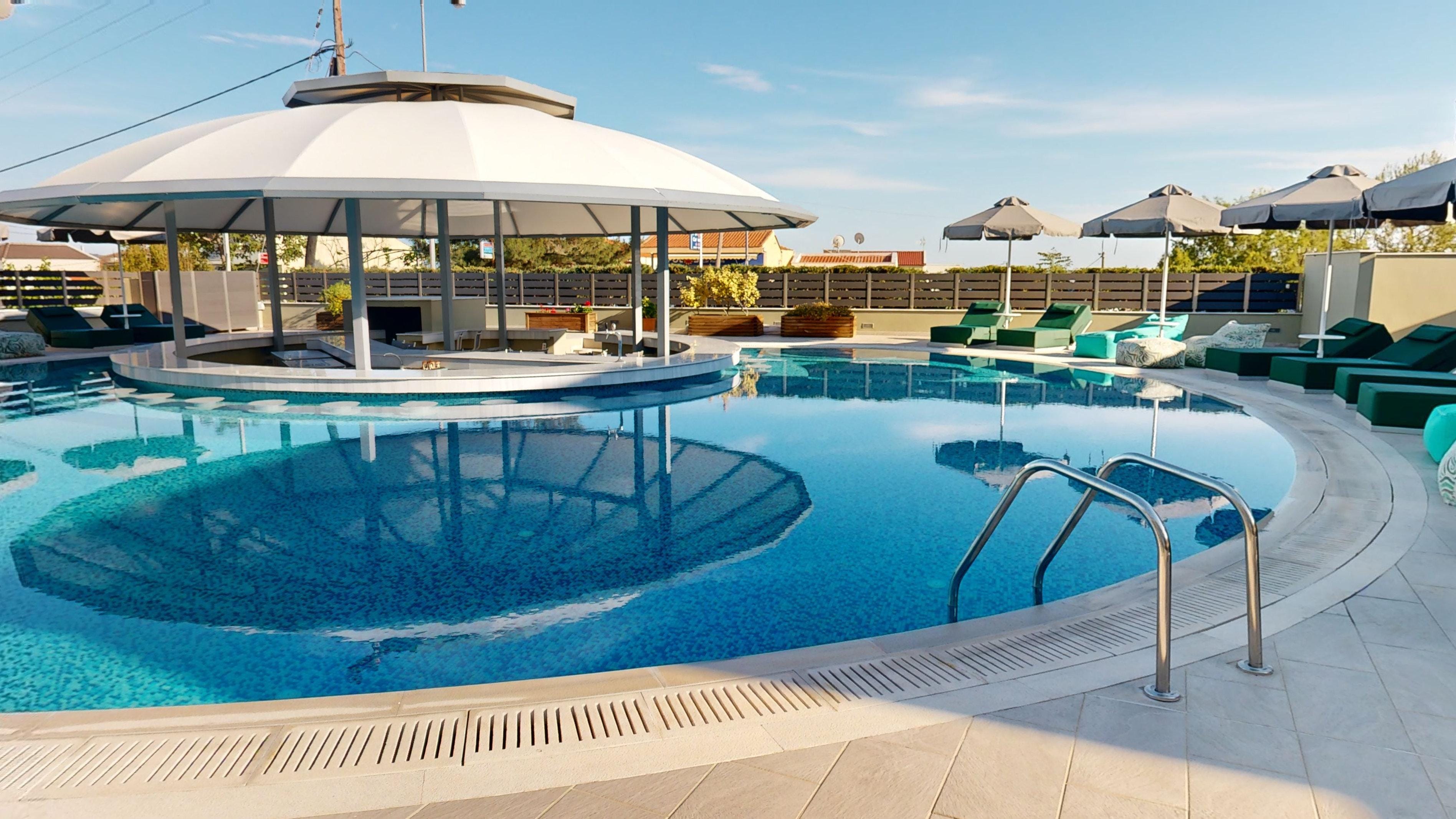 a pool with a lounge chair and umbrellas by it