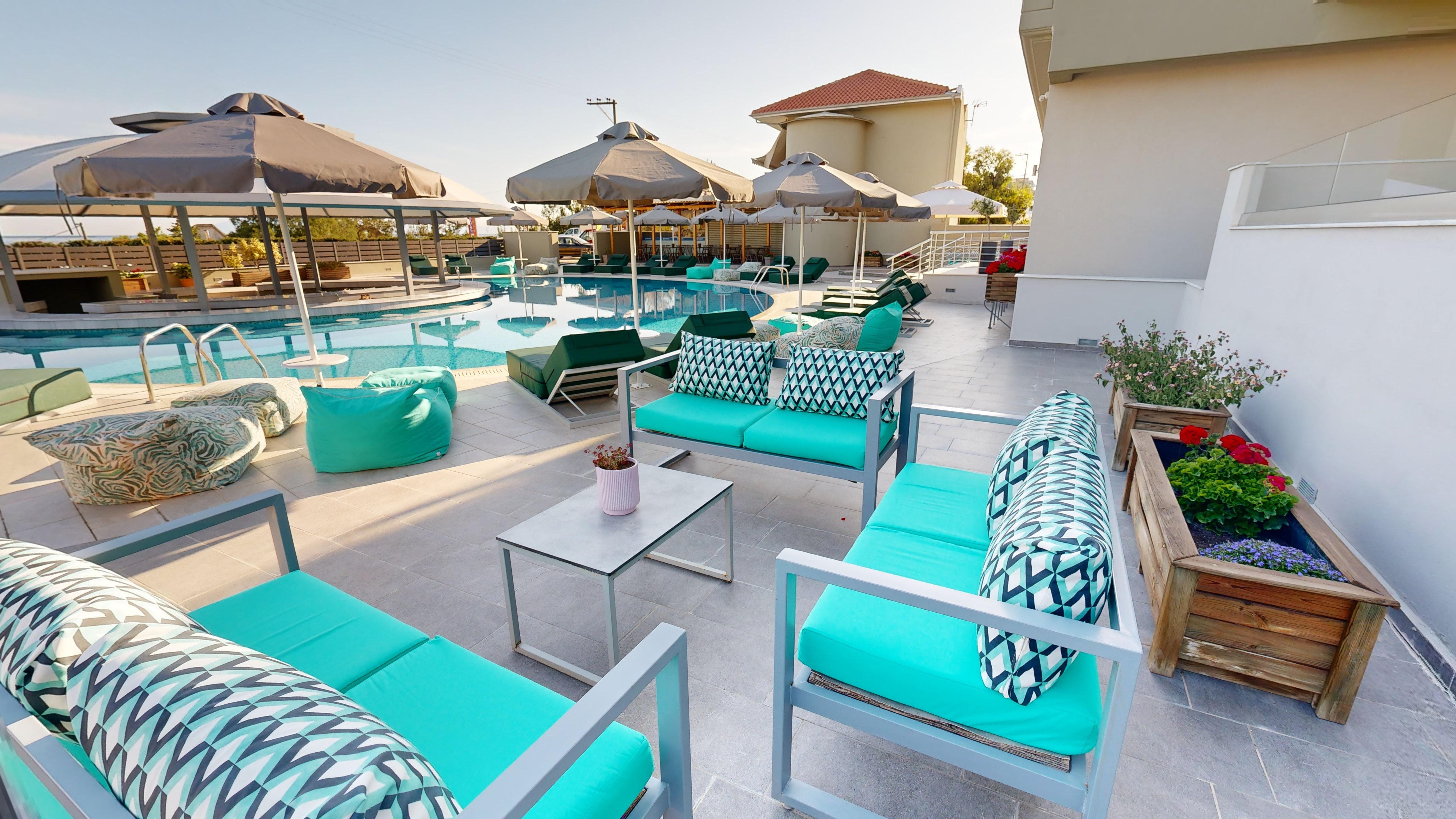 a pool with lounge chairs and umbrellas