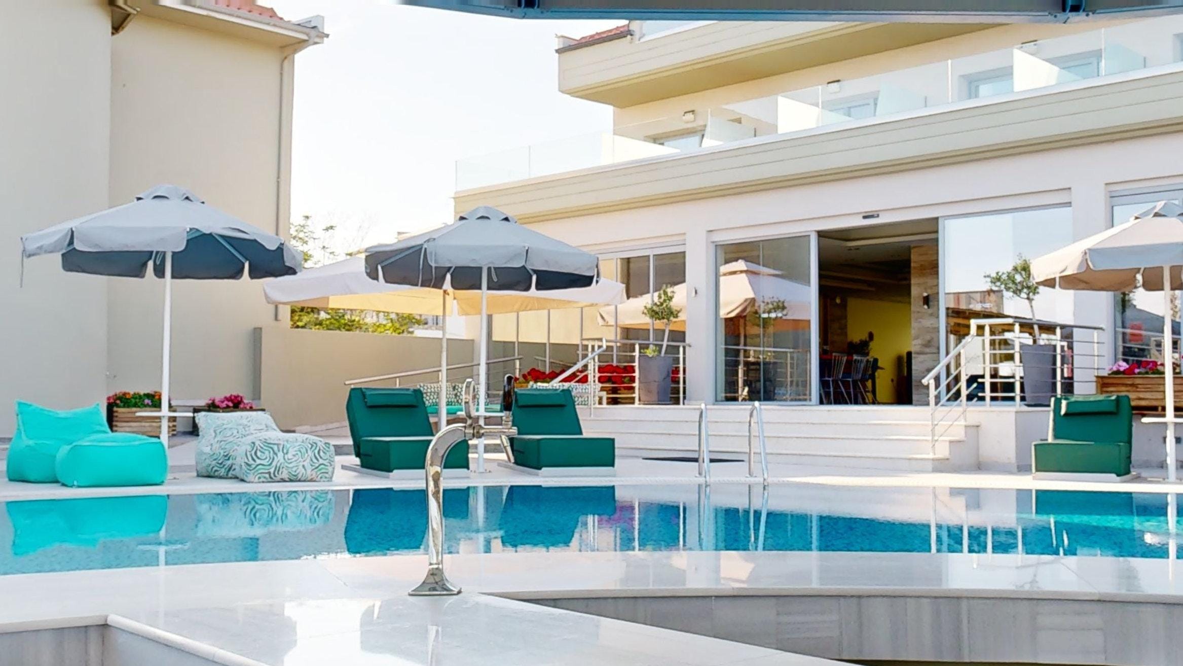 a pool with chairs and umbrellas