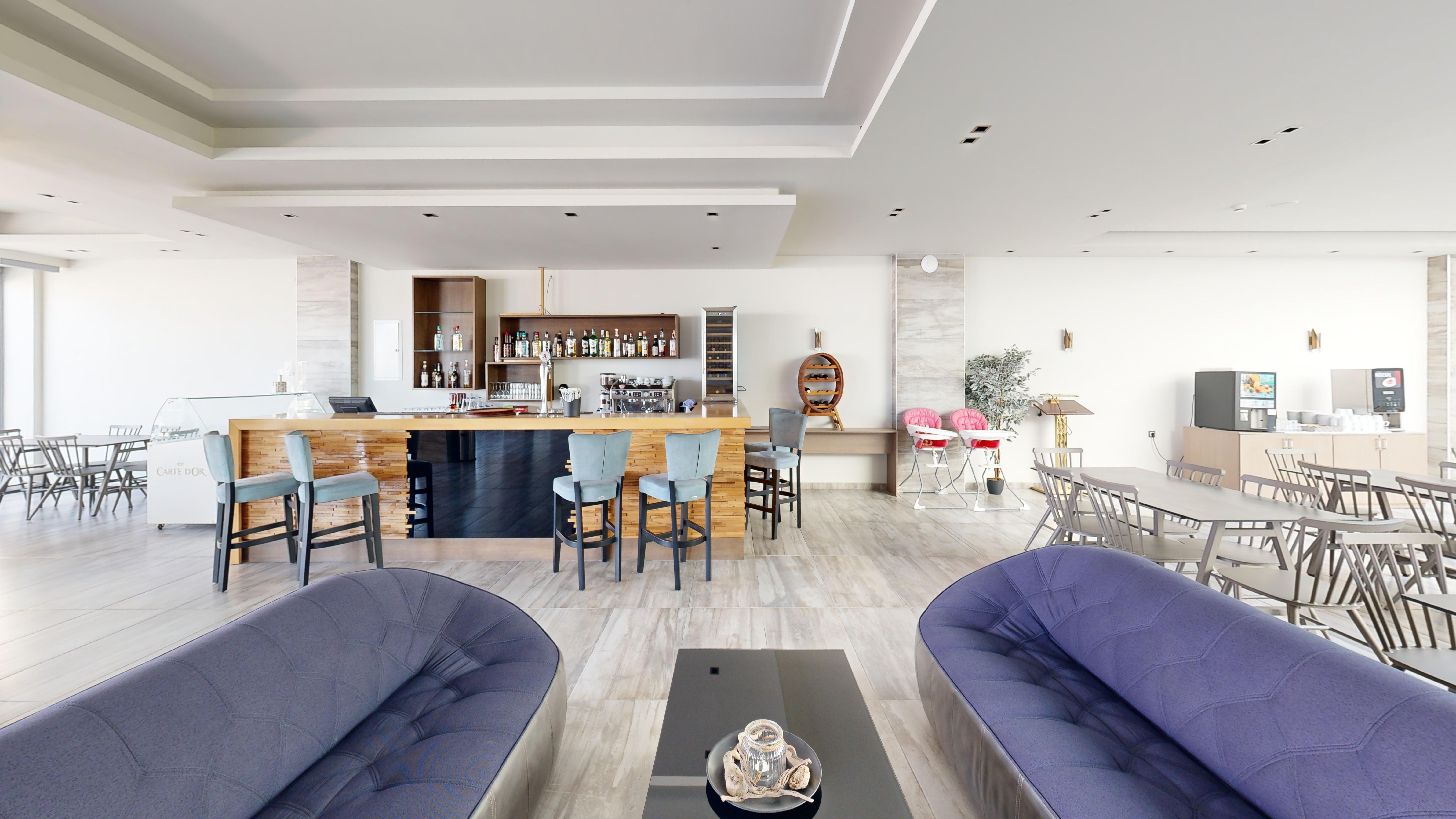 a room with a table chairs and a couch