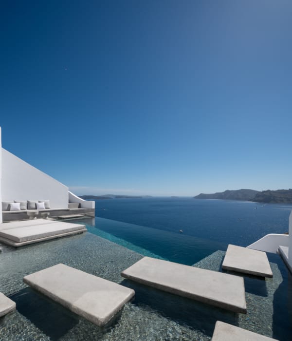 a group of white buildings next to a body of water