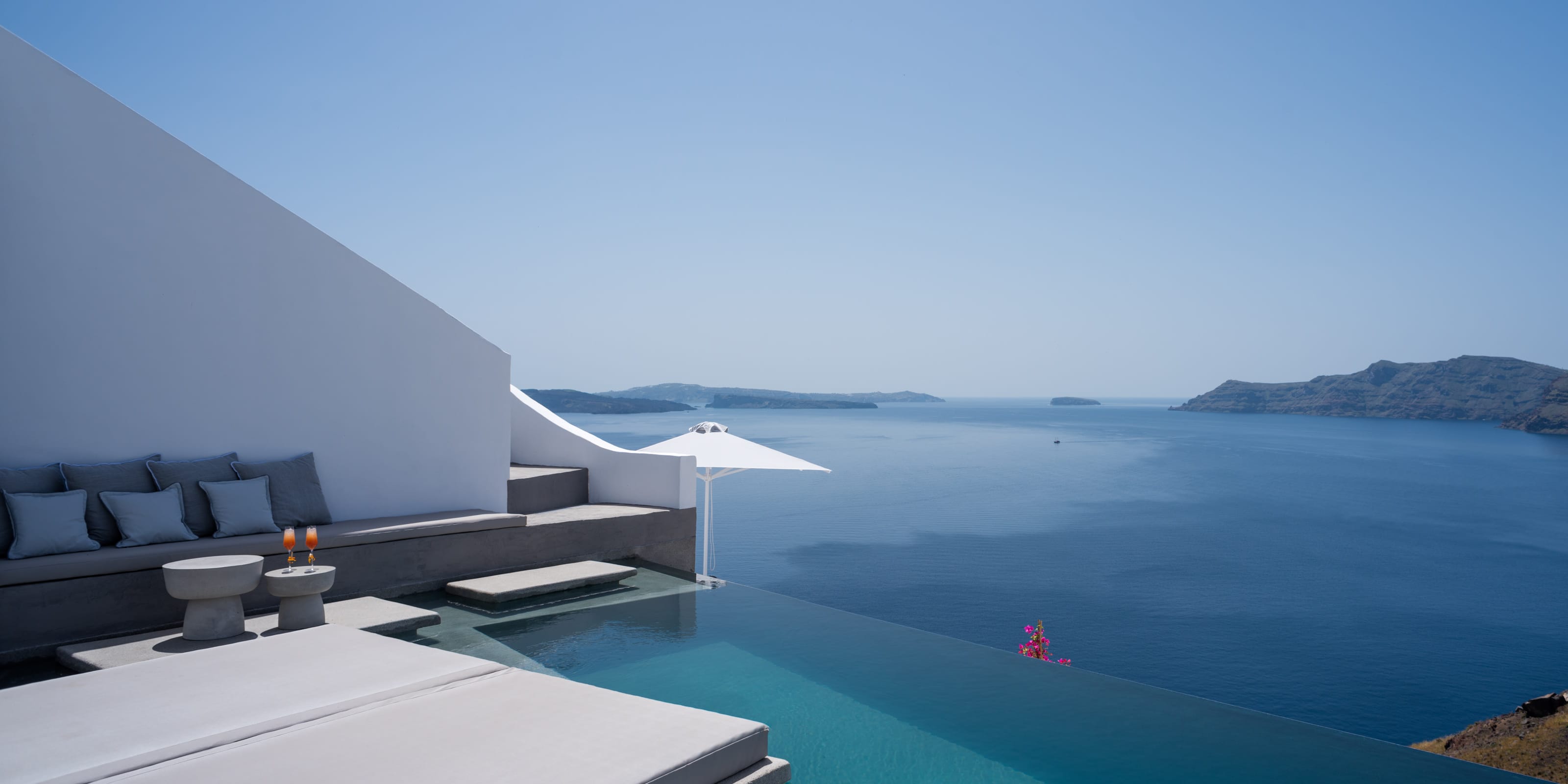 a pool with a white umbrella
