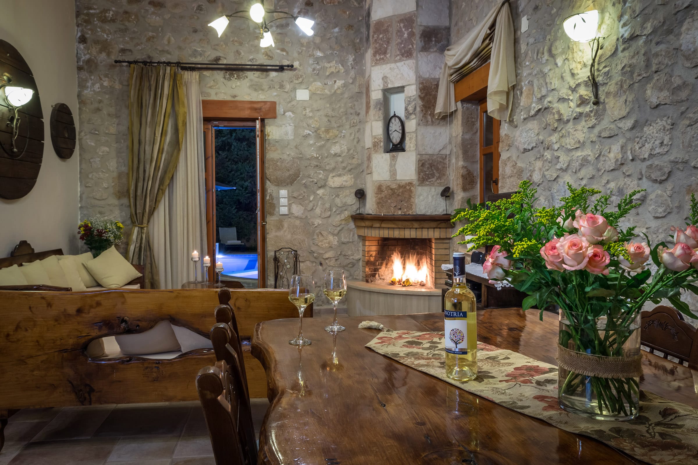 a table with wine glasses and flowers
