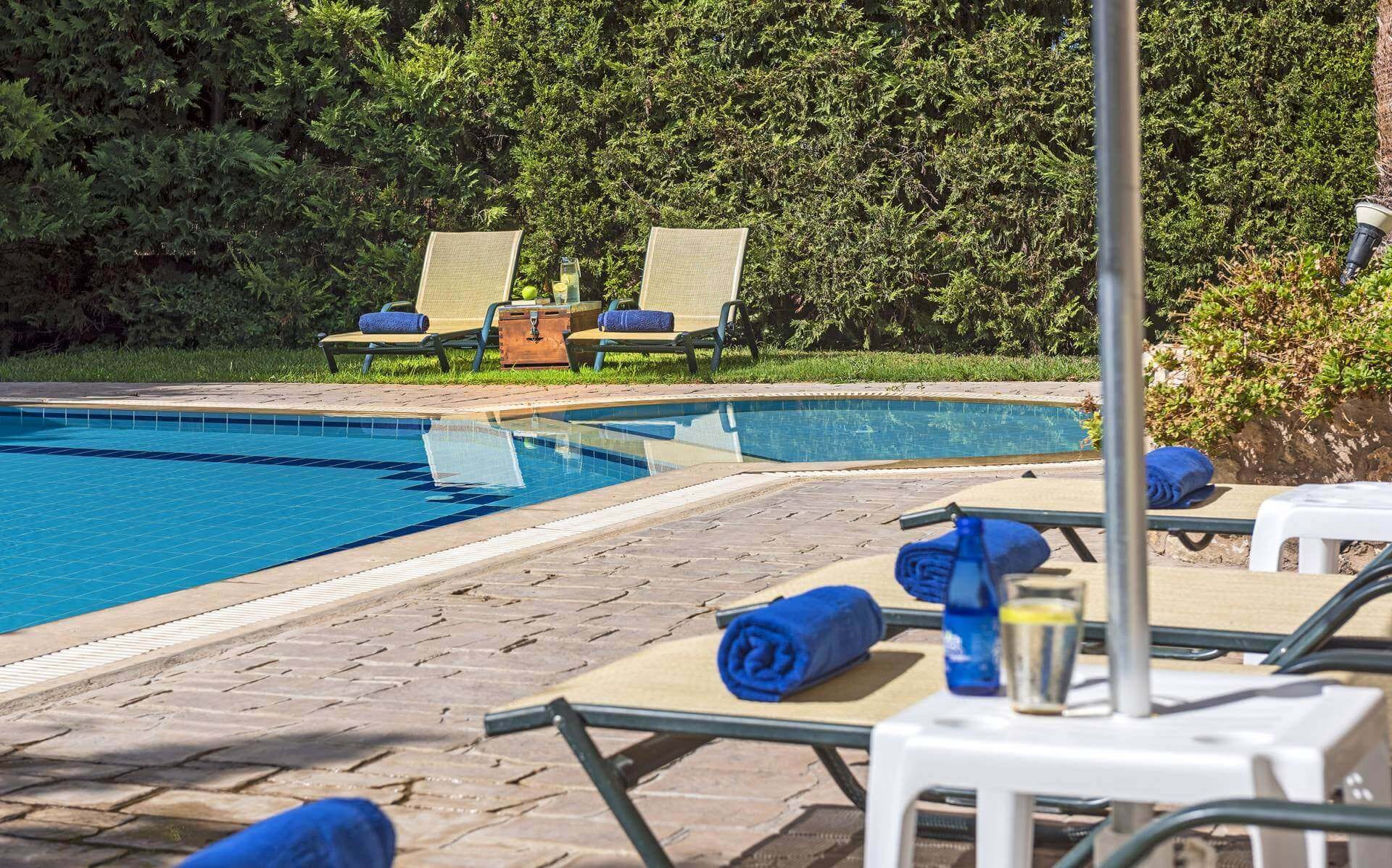 a pool with chairs around it