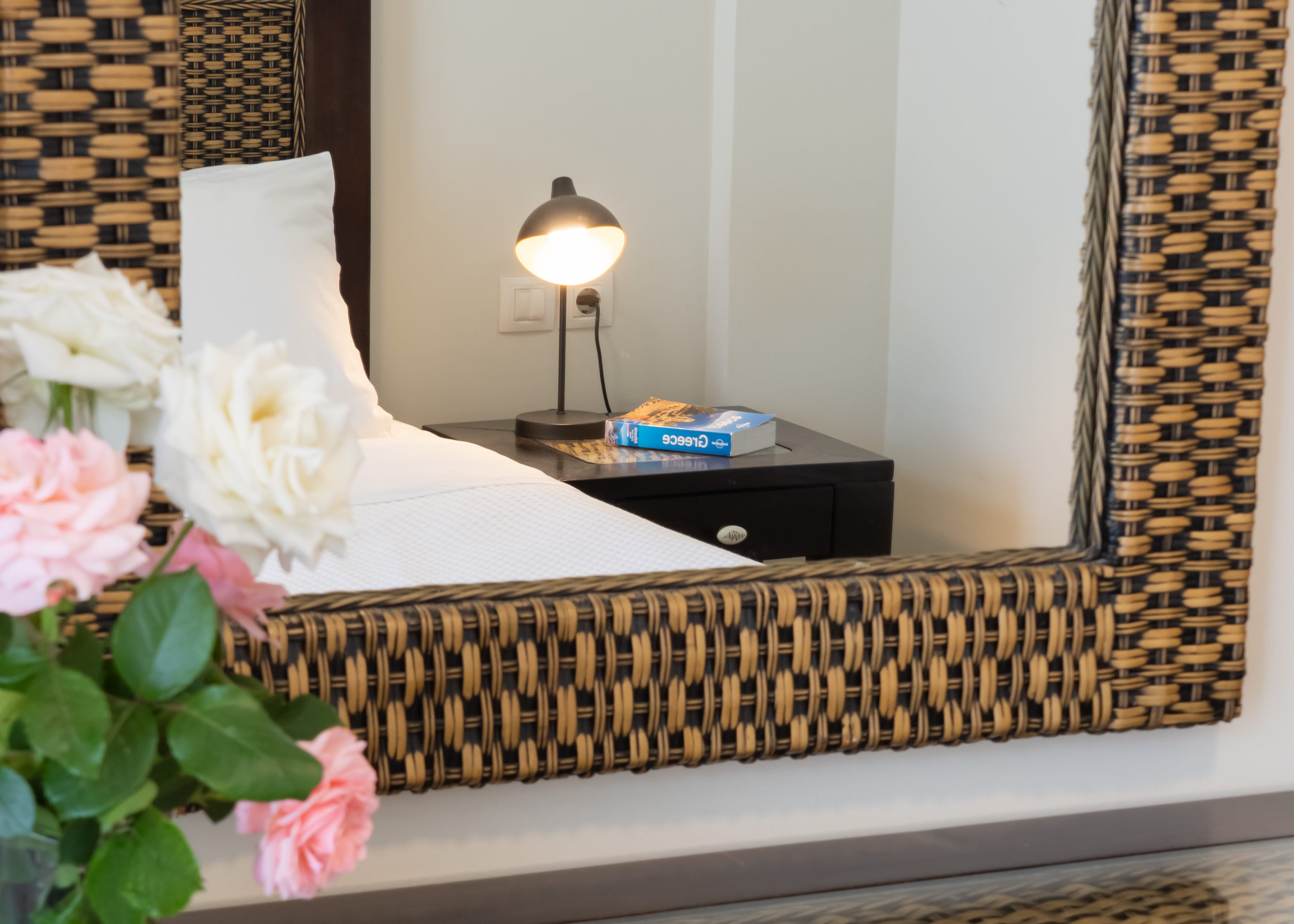 a bed with a white pillow and a lamp on the side