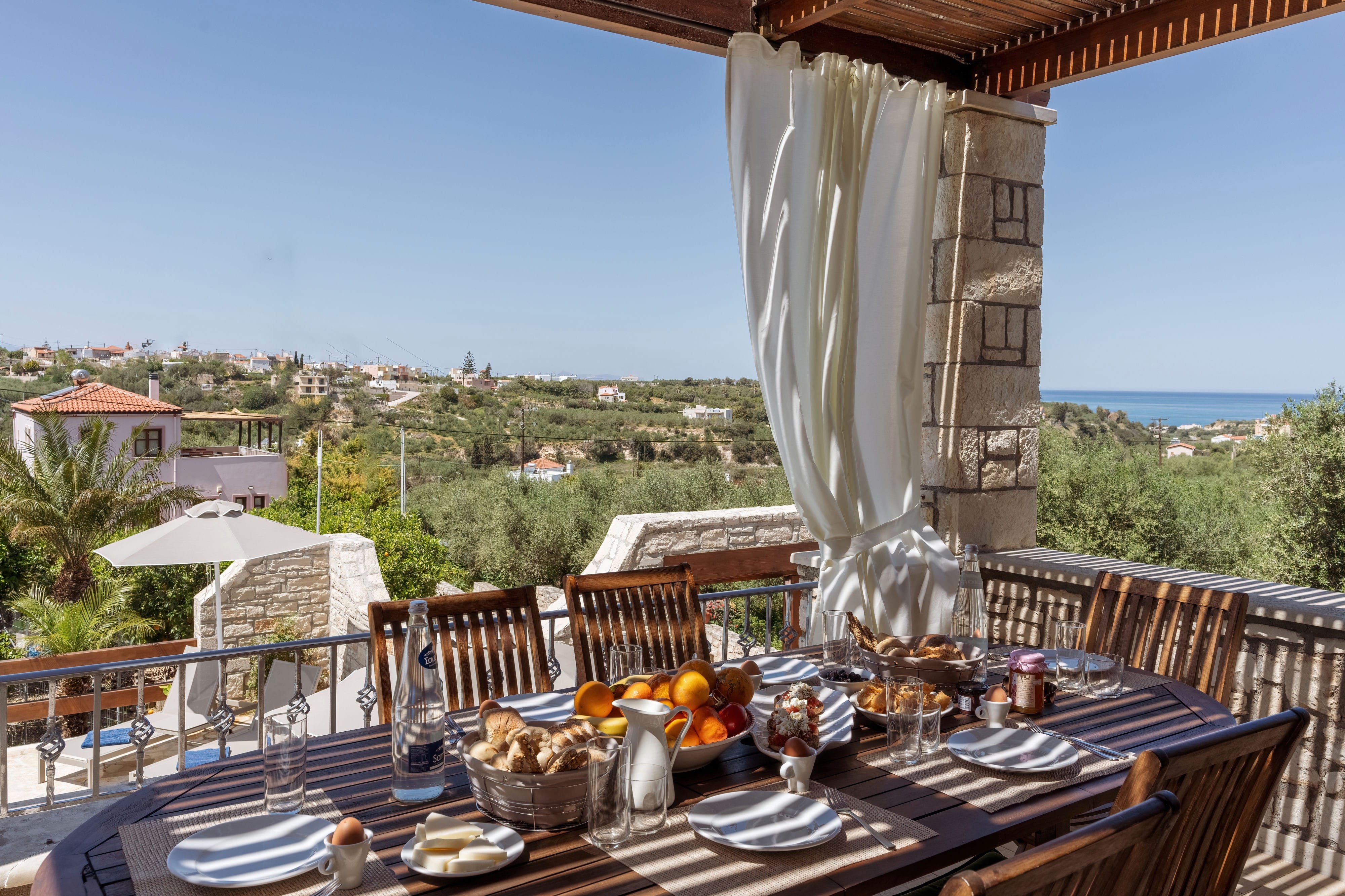 a table with food and drinks on it on a balcony