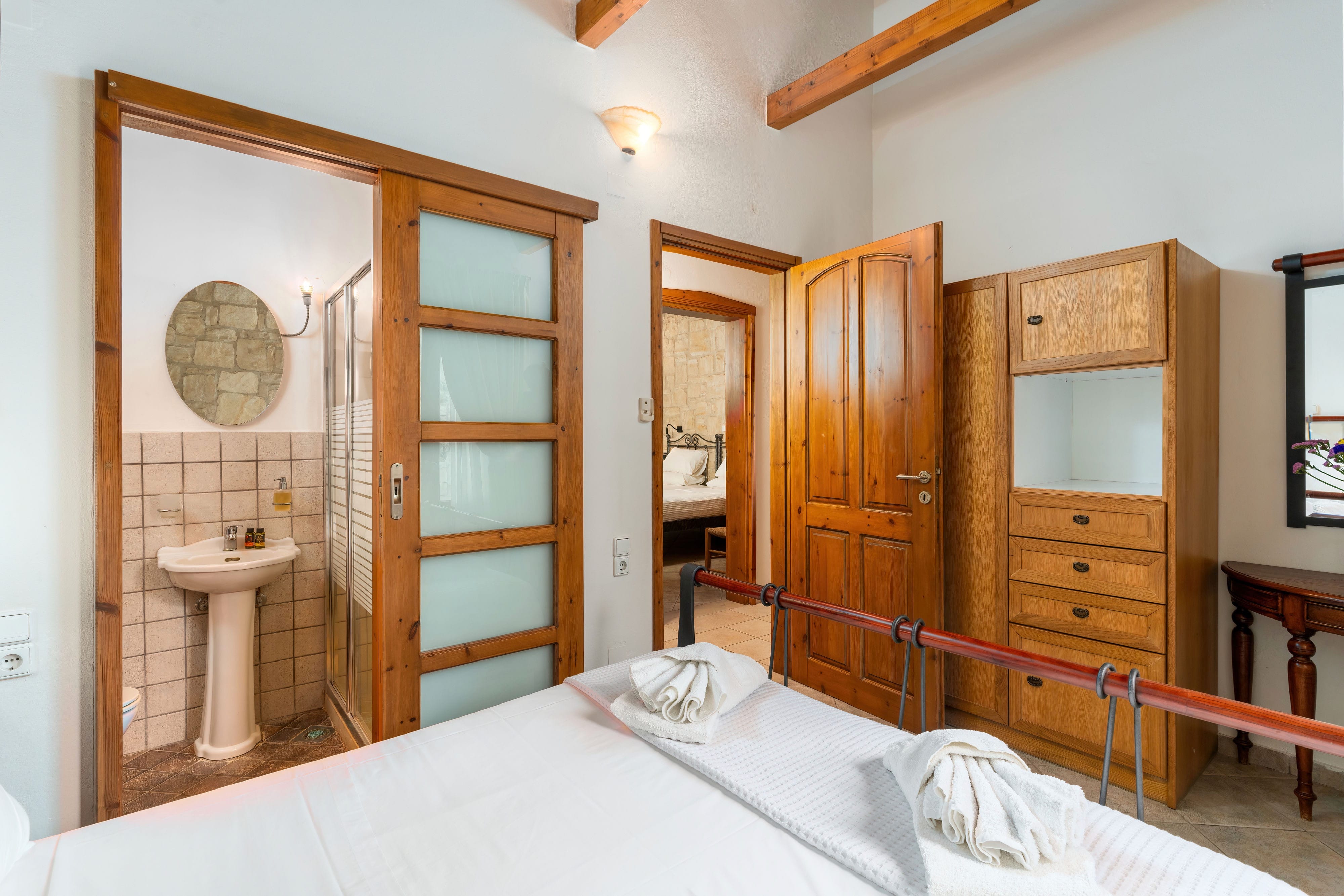 a bathroom with a bed and sink