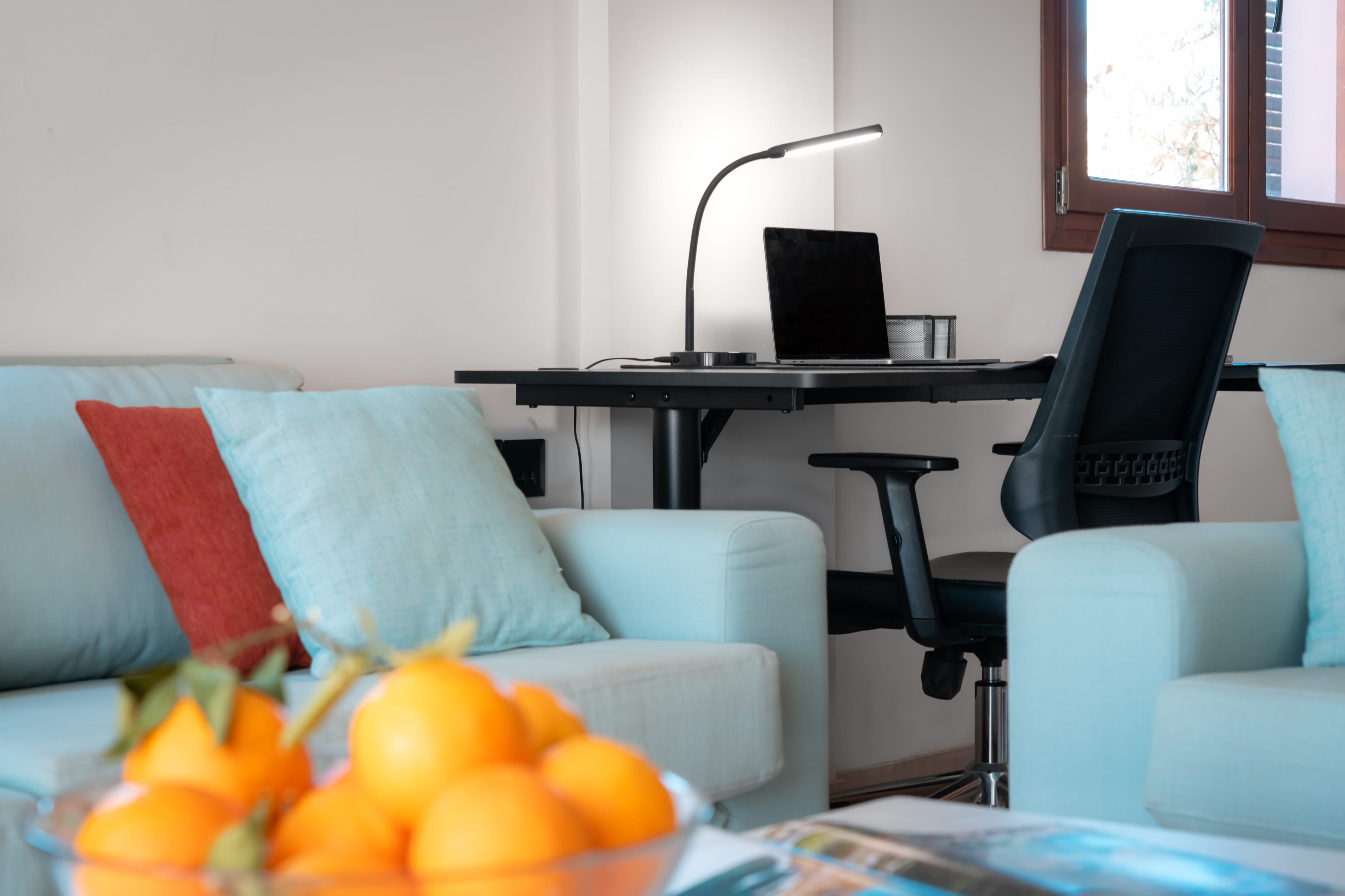 a room with a desk and chairs