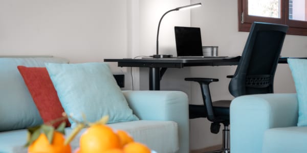 a room with a desk and chairs