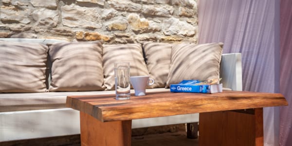 a coffee table with a glass of water on it