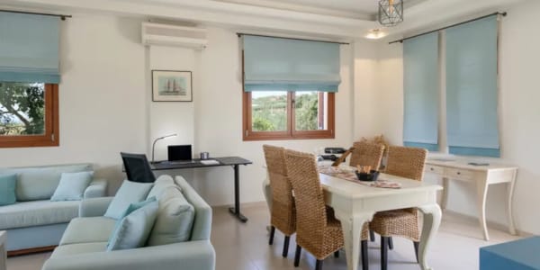 a living room with a table and chairs