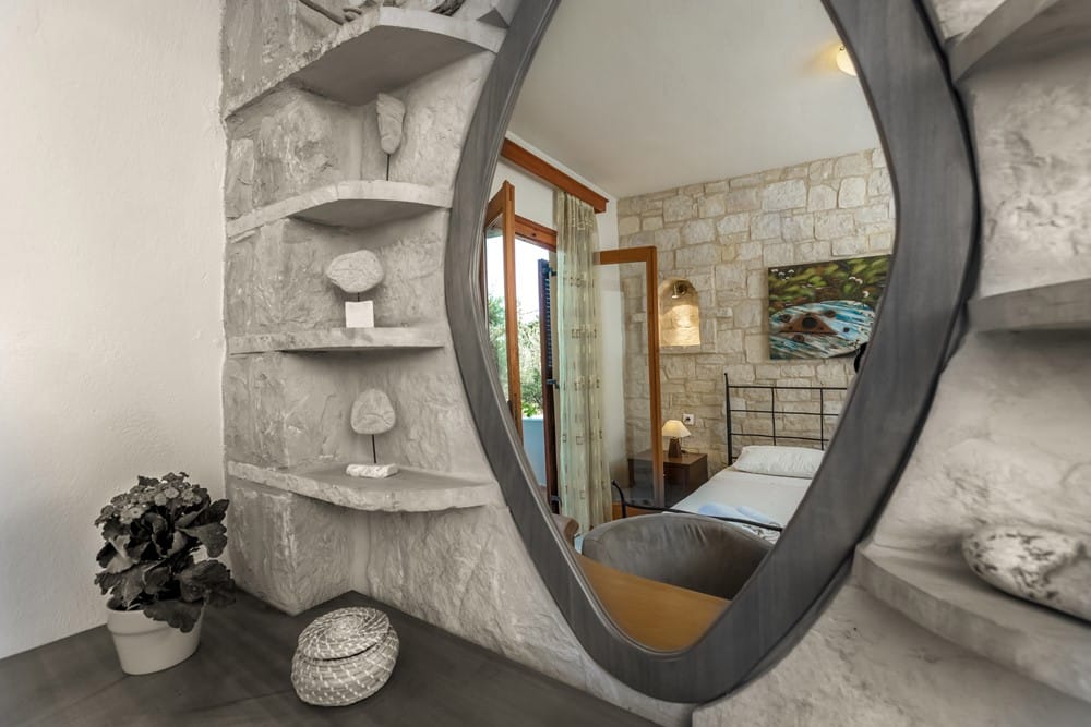 a room with a mirror and a fireplace