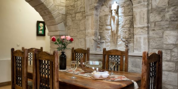 a dining table with a vase of flowers on it