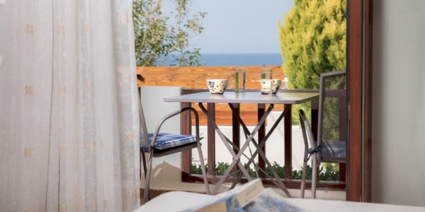 a table with a glass of wine on it by a window