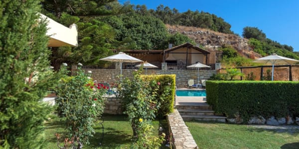 a house with a pool and bushes