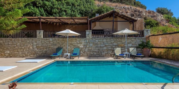 a pool with chairs and umbrellas