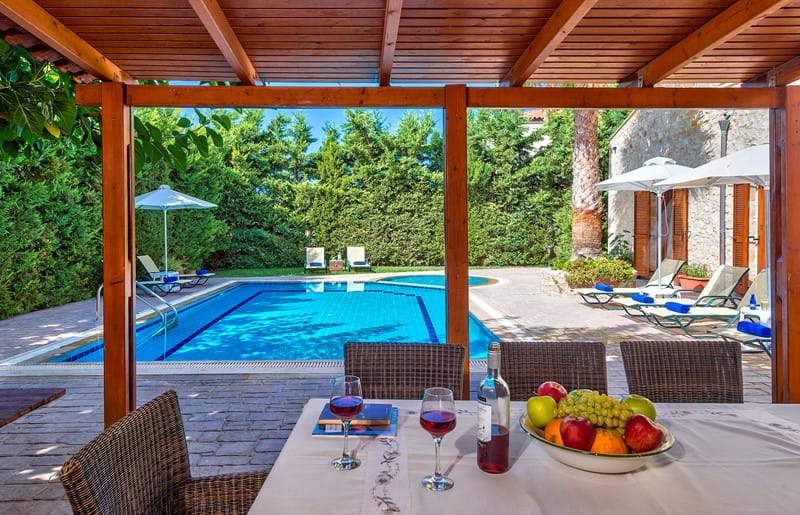 a pool with a table and chairs