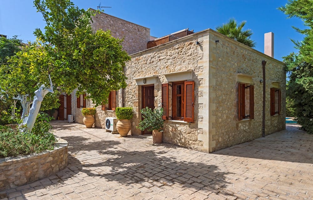 a stone house with a stone driveway