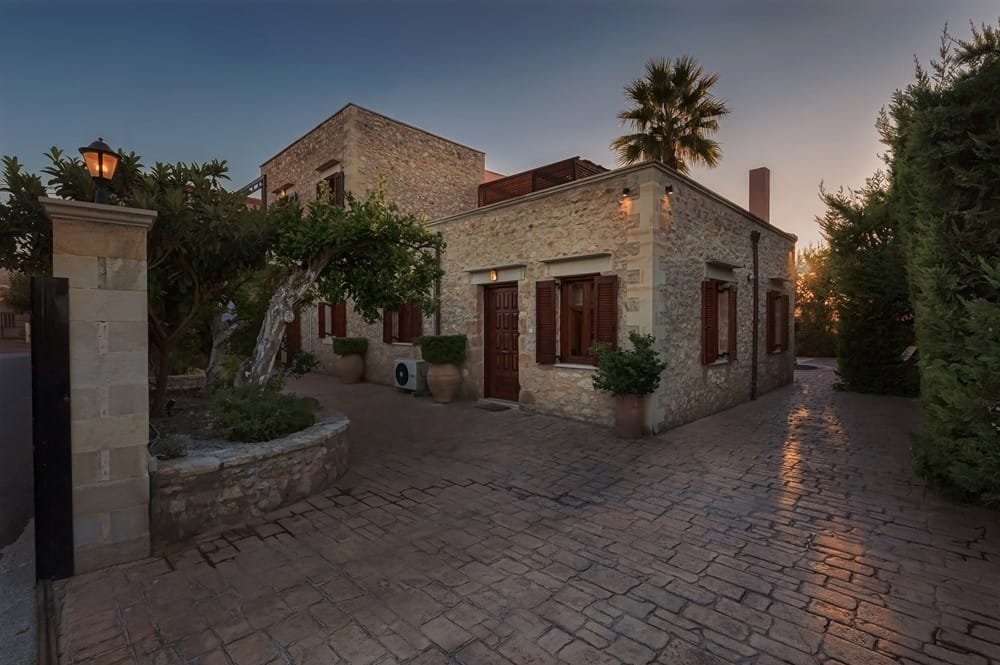 a stone driveway leading to a house