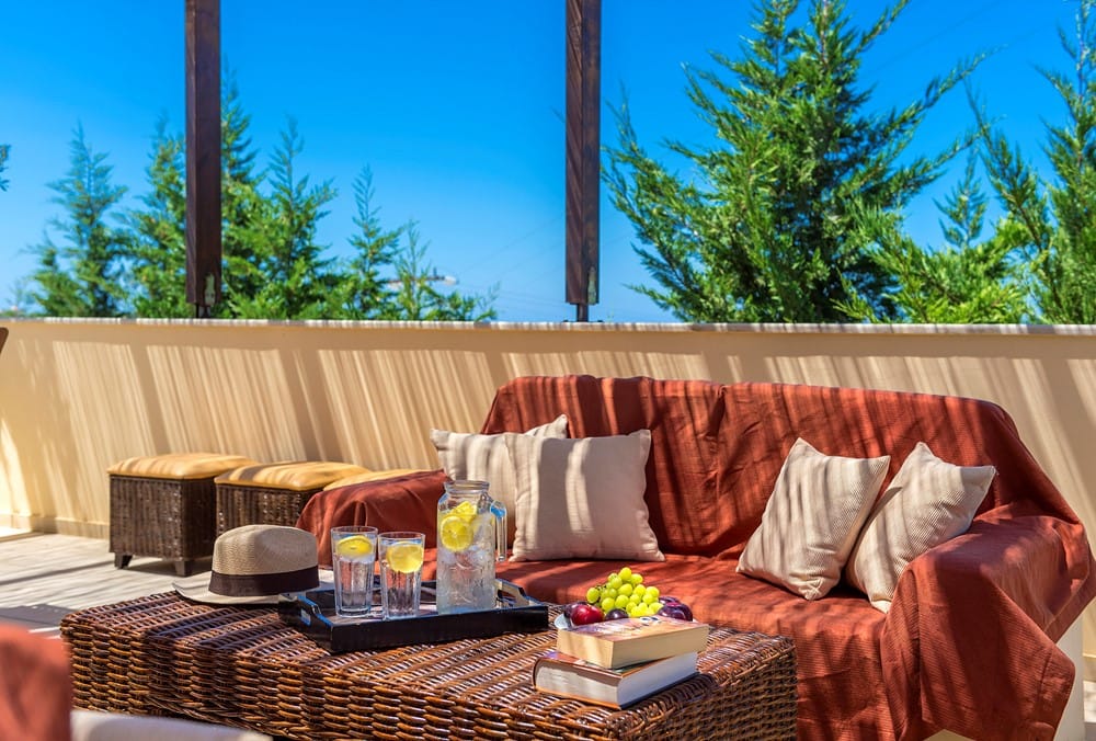 a couch with a table and a hat on it