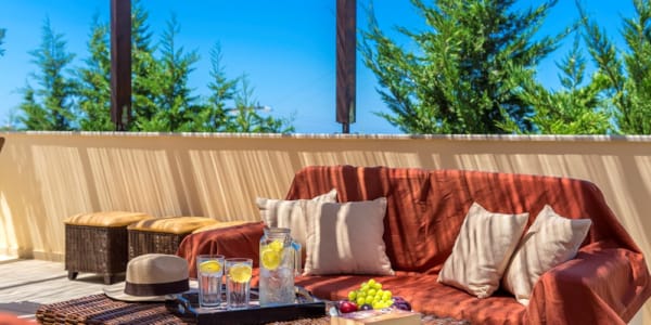 a couch with a table and a hat on it