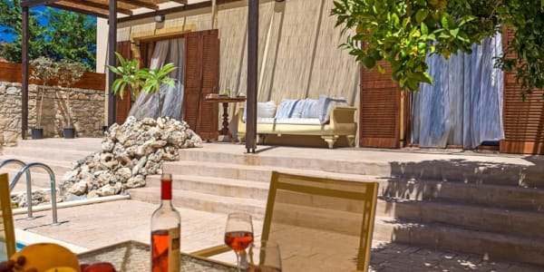 a table with glasses of wine and a bottle of wine on it