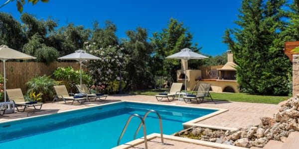 a pool with chairs and umbrellas