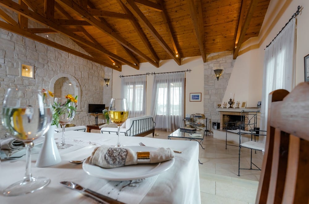 a large dining room with a large white table and chairs