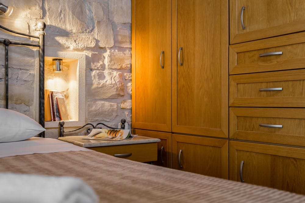 a bedroom with a mirror and a bed