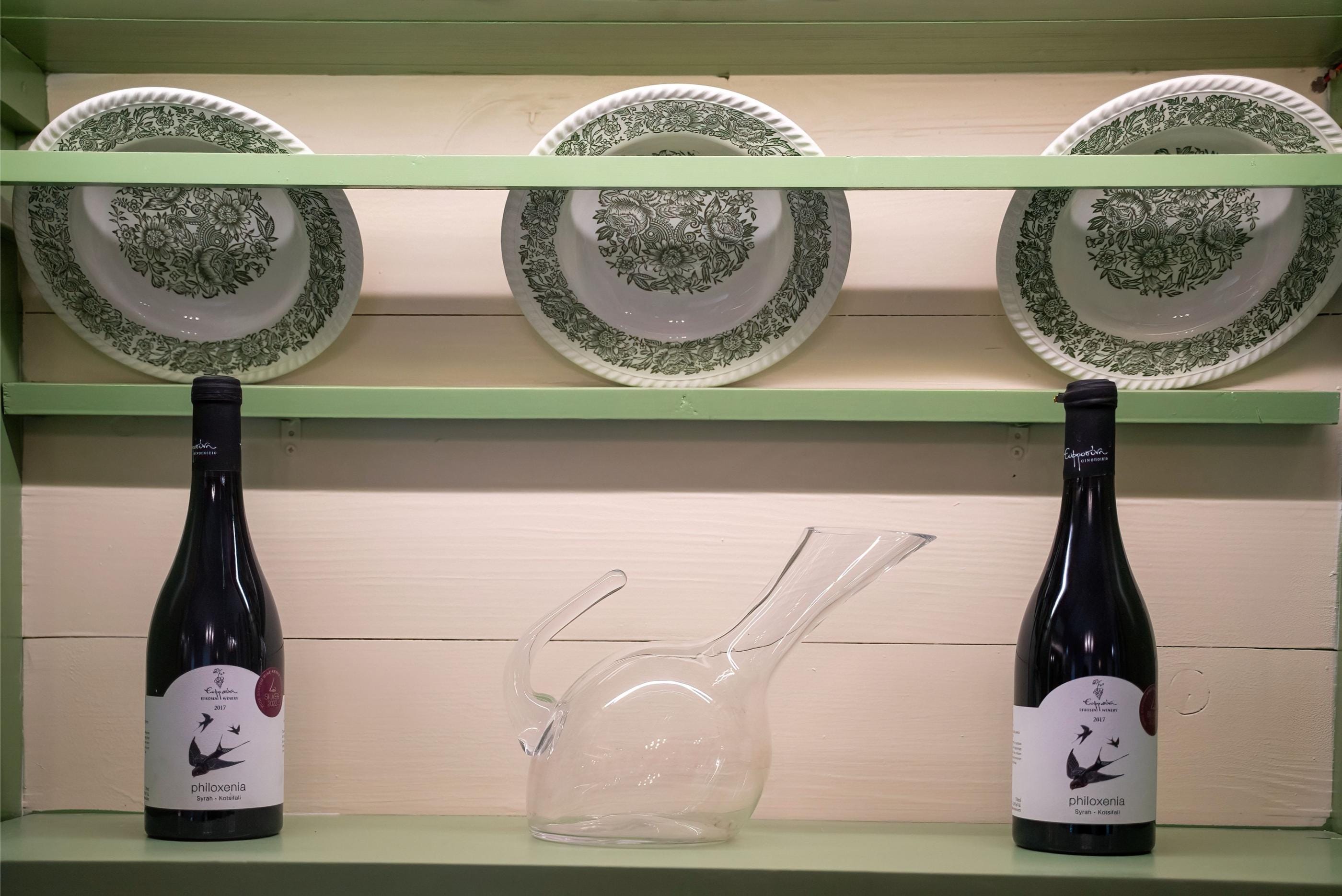 a shelf with bottles and glasses on it