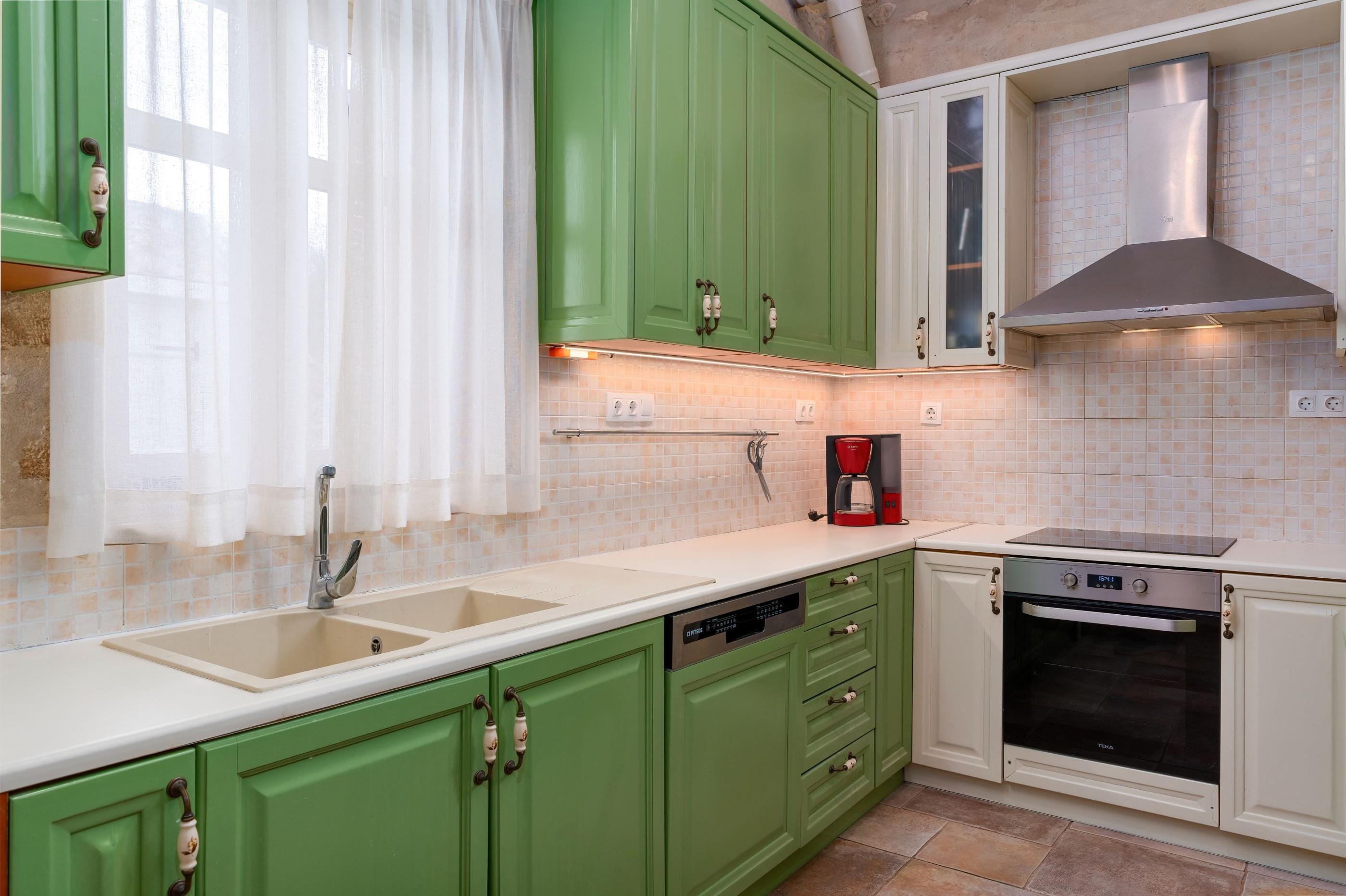 a kitchen with green cabinets
