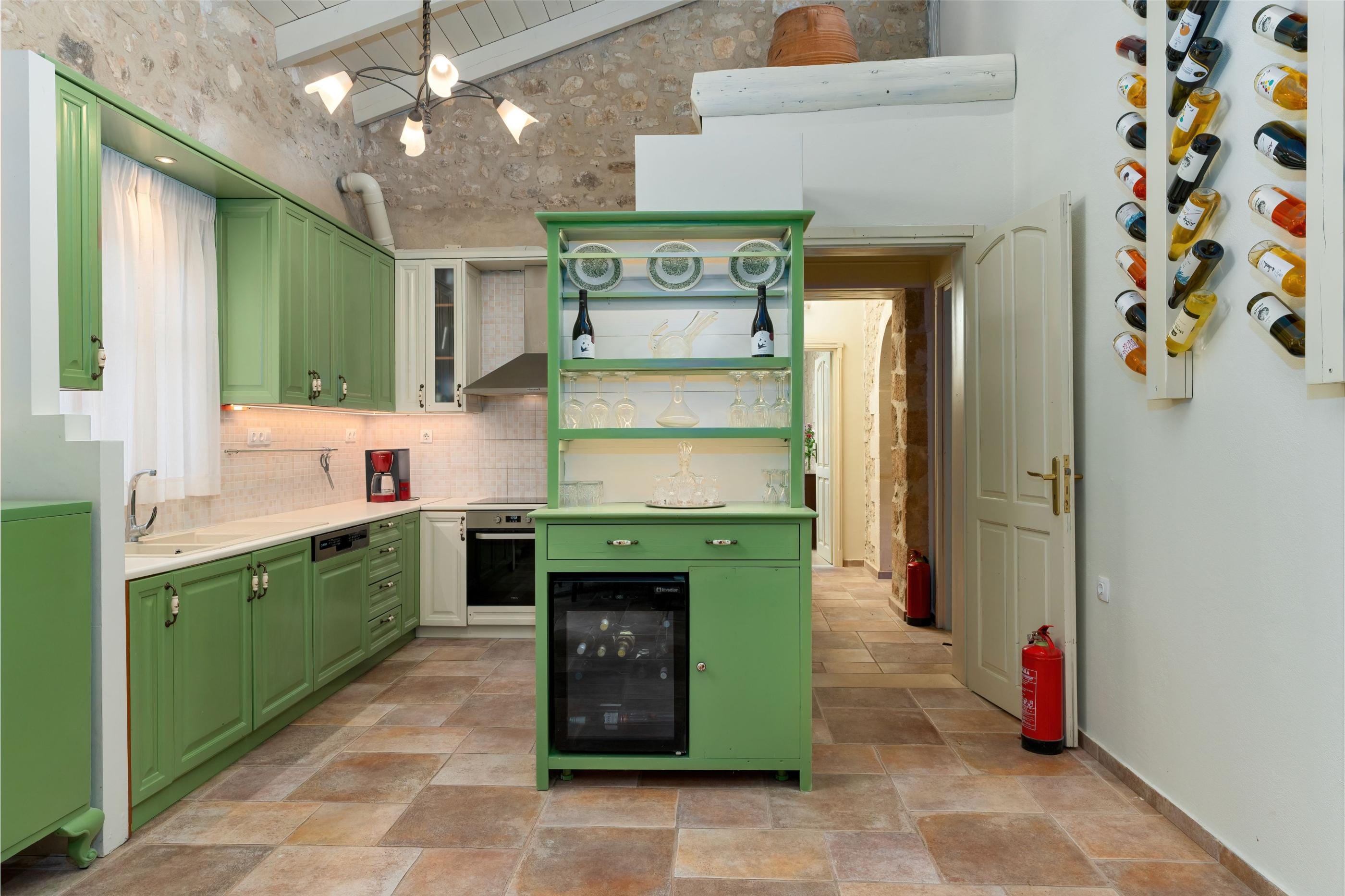a kitchen with green cabinets