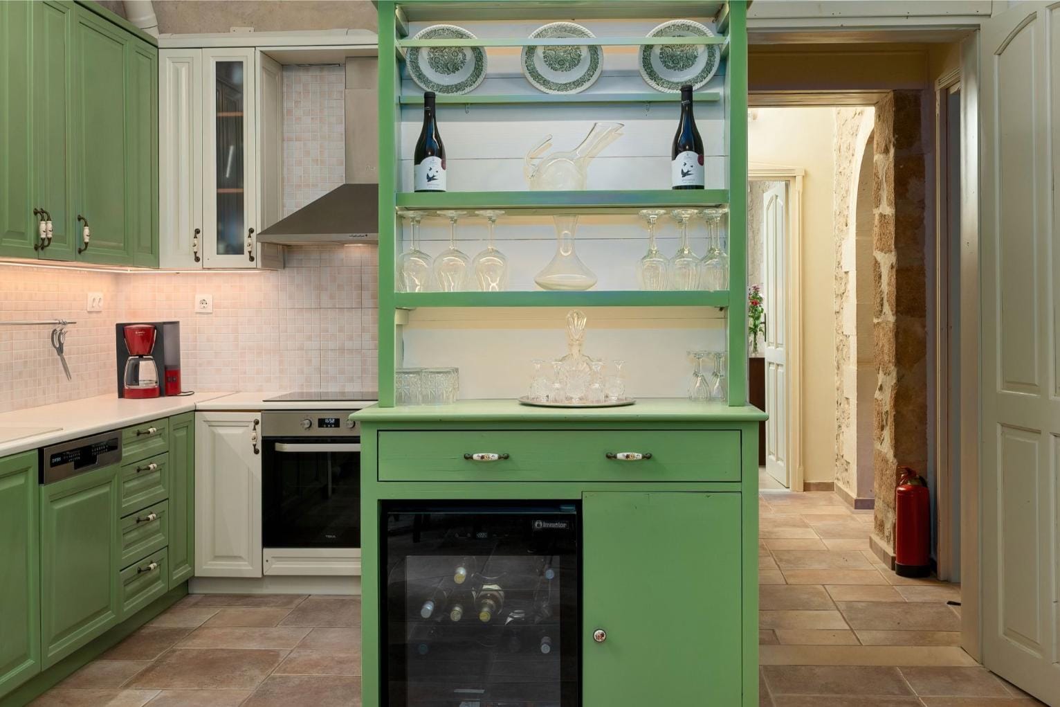 a kitchen with green cabinets