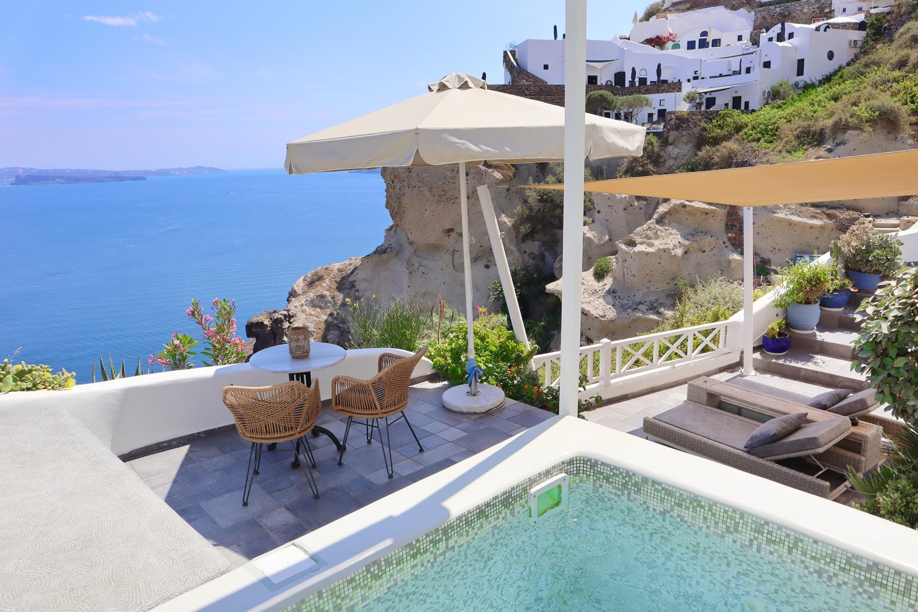 a pool with a lounge chair and umbrella on a deck