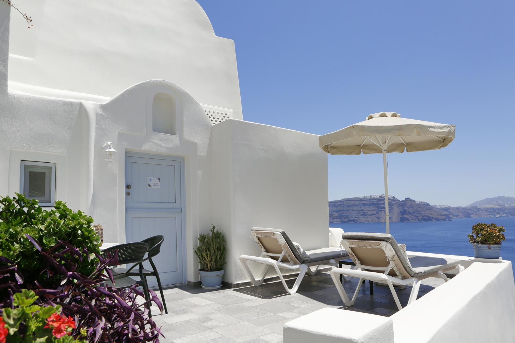 a patio with chairs and umbrellas