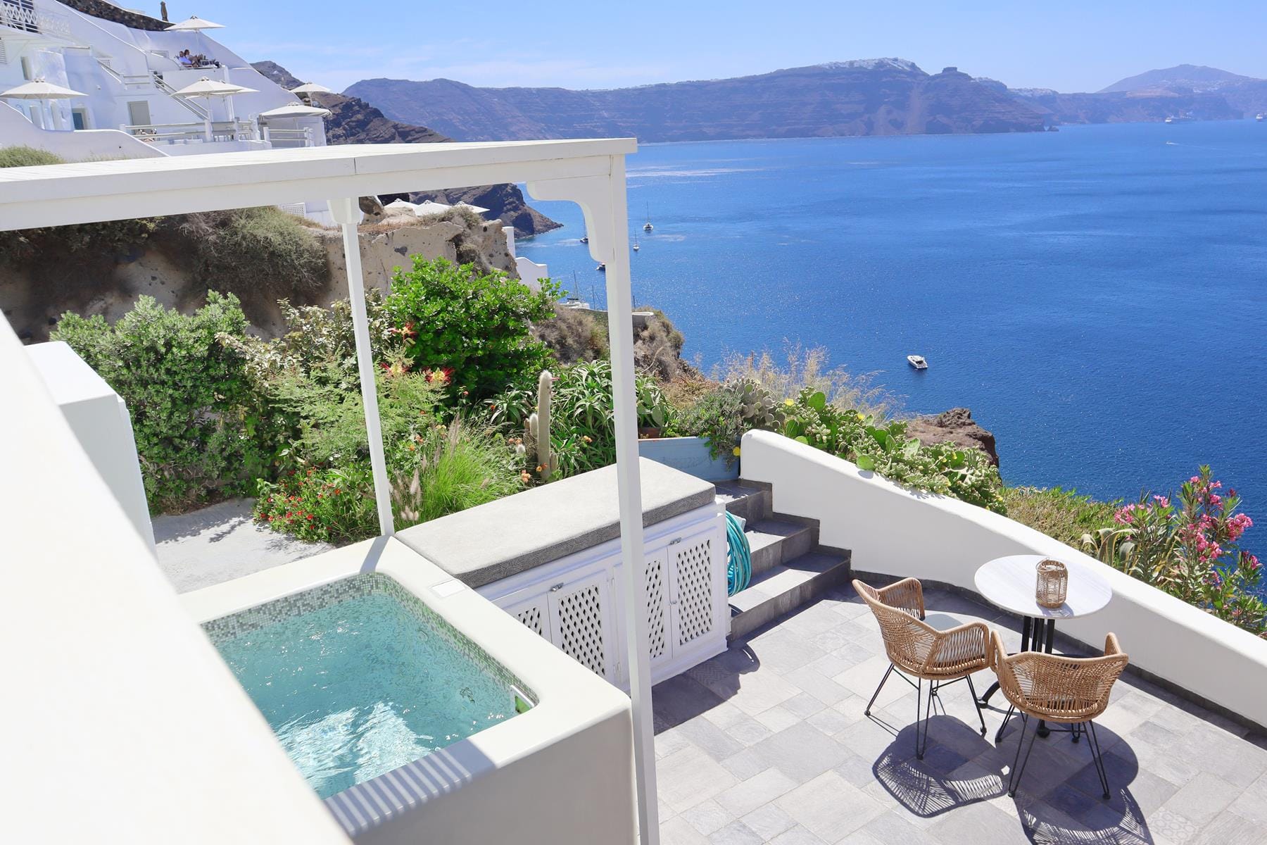 a pool and a deck overlooking the ocean