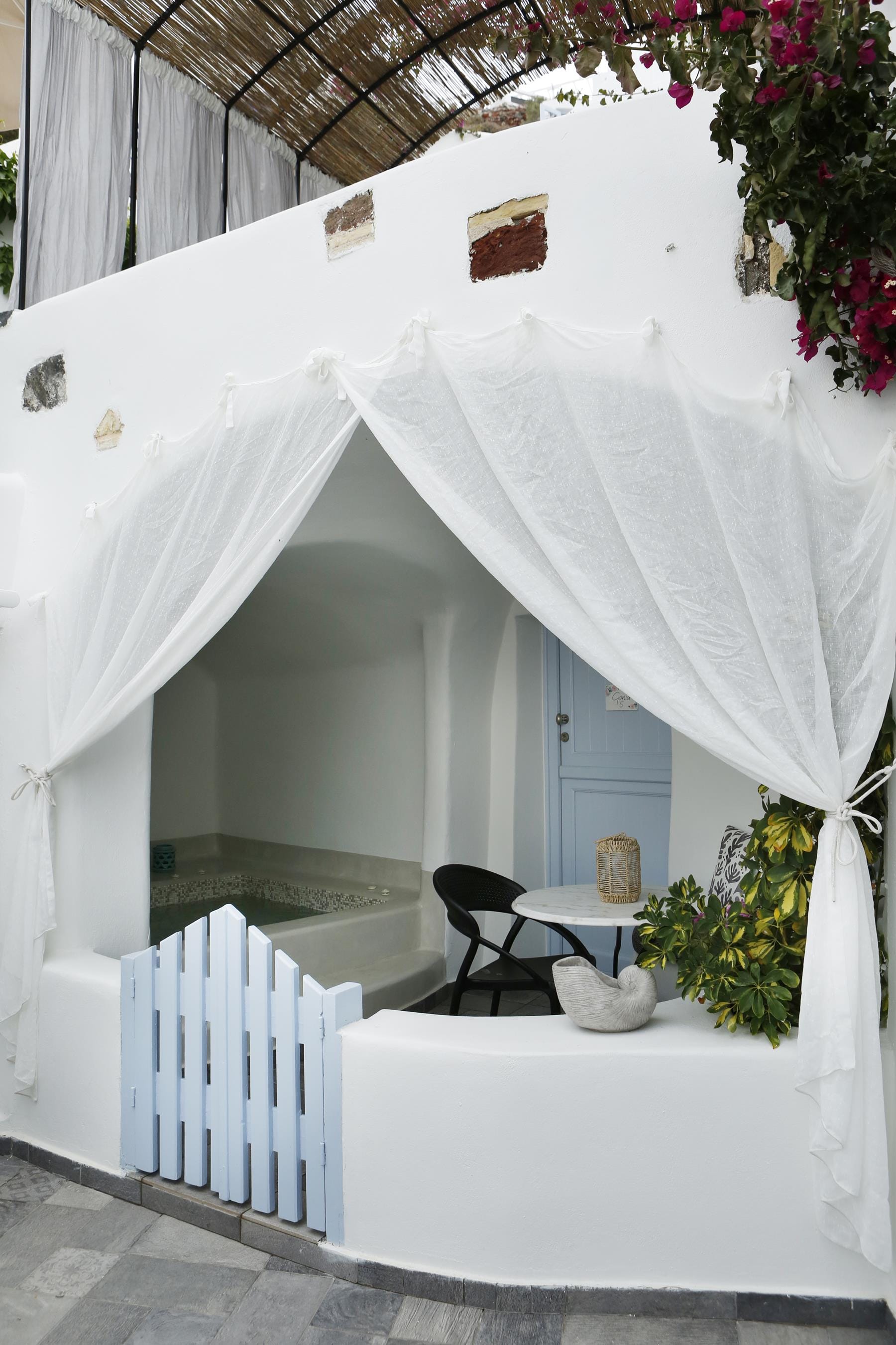 a white canopy with a table and chairs in front of it