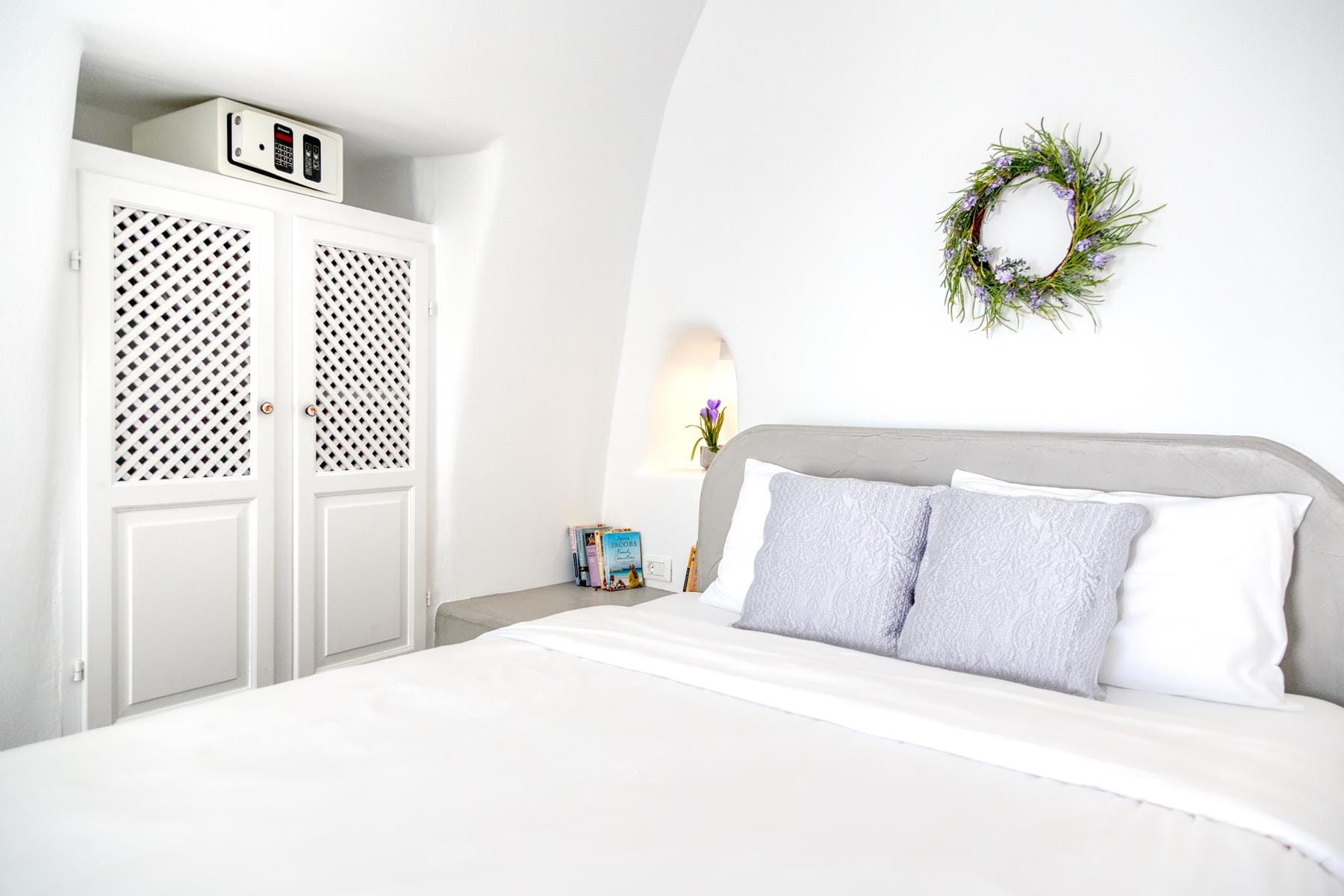 a bed with white sheets and pillows