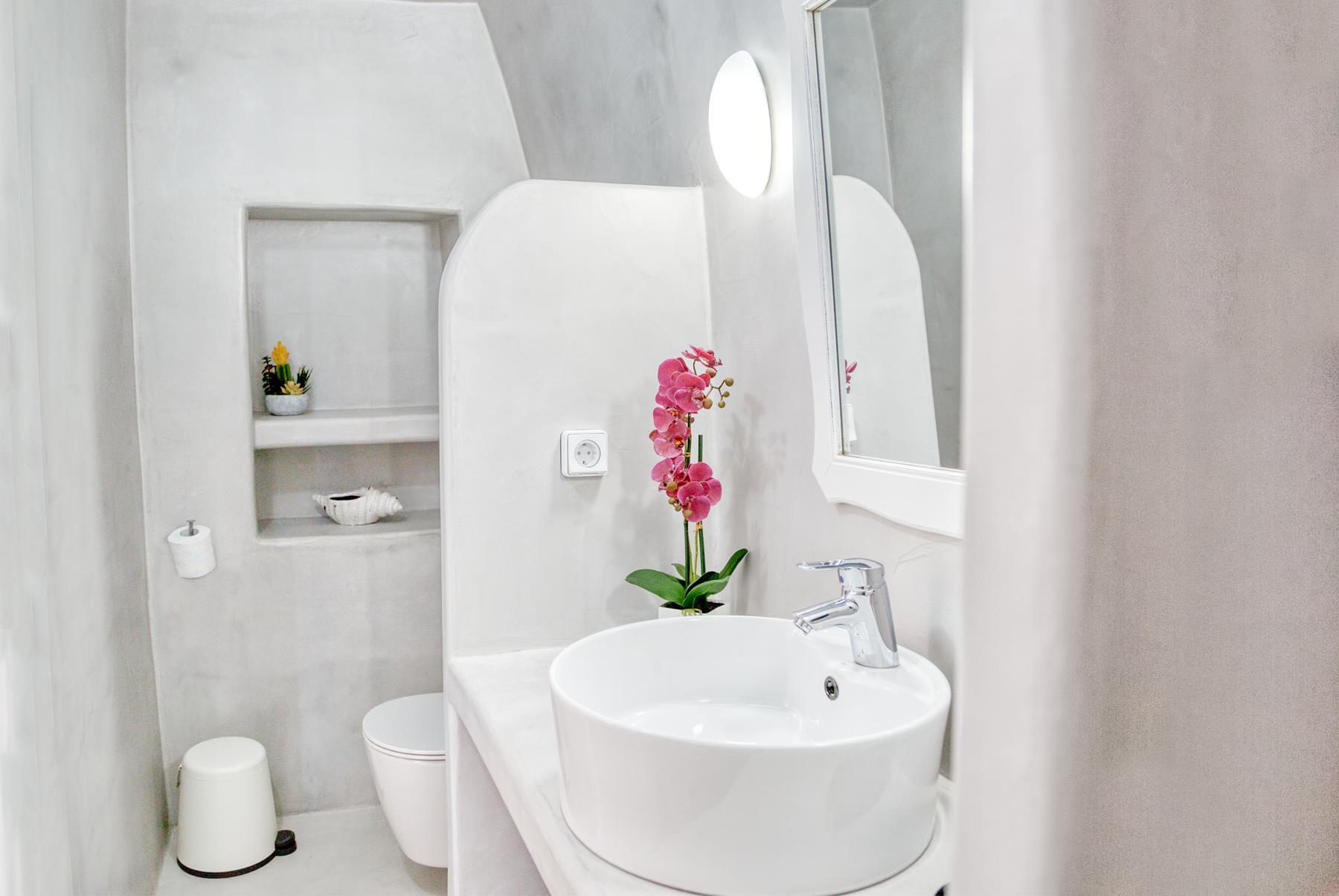 a bathroom with a flower in the sink