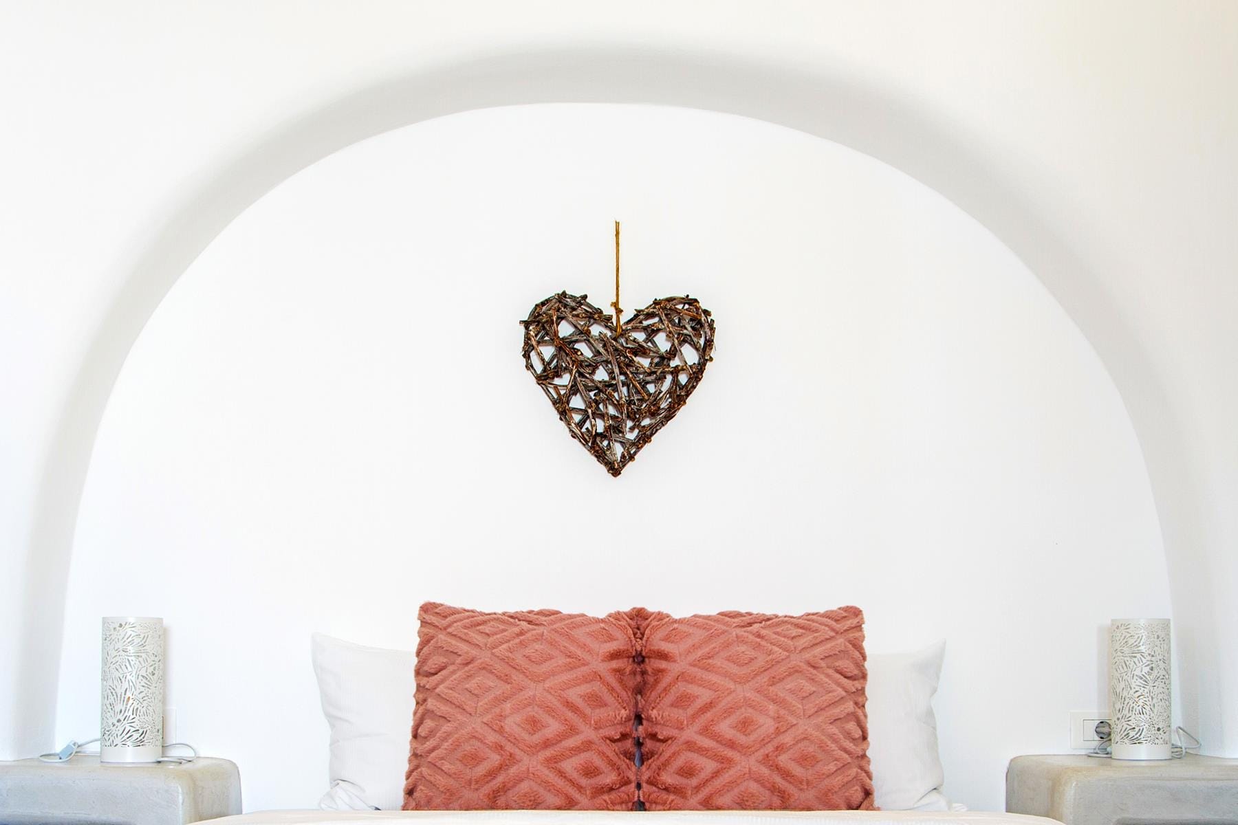 a heart shaped pillow on a bed