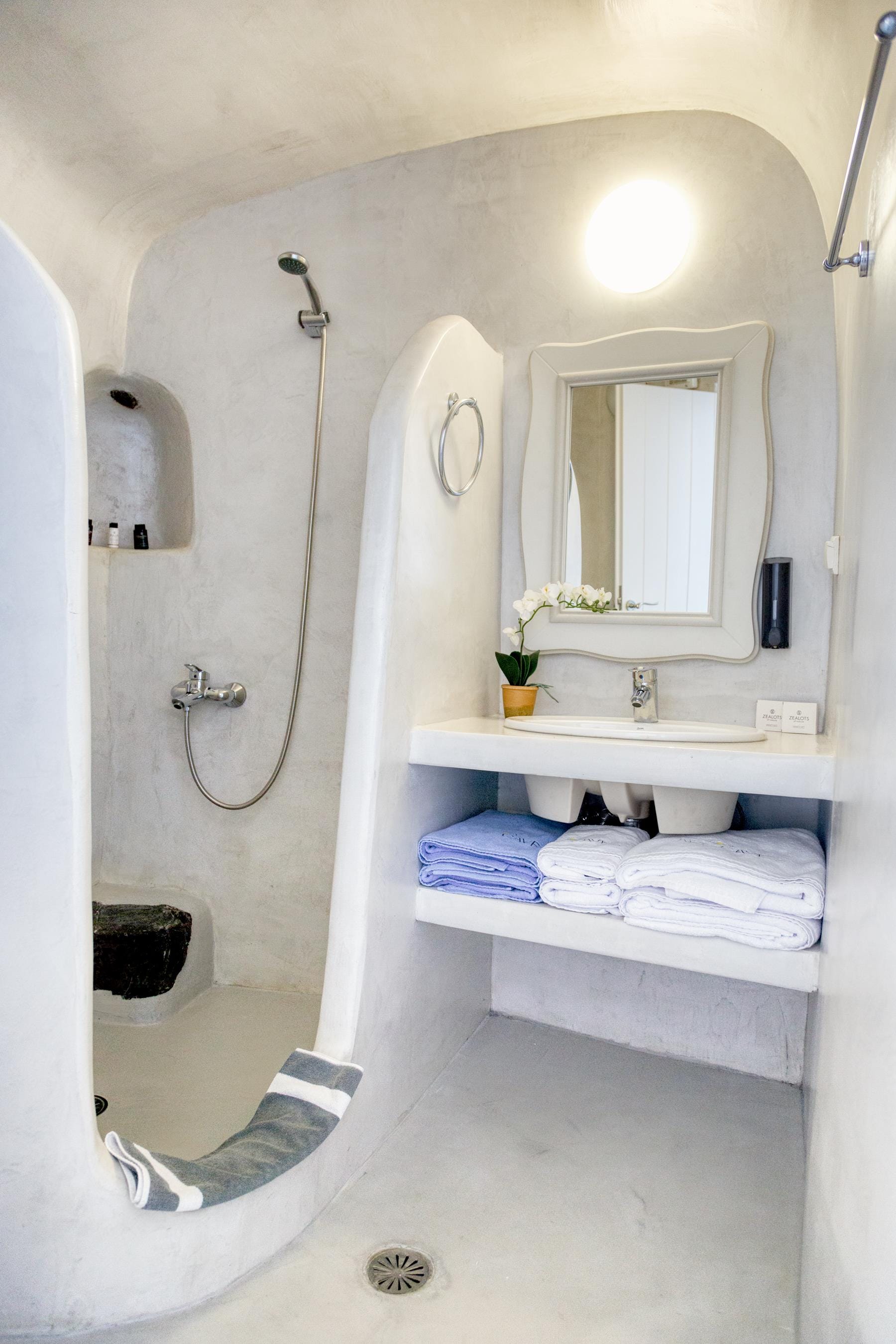a bathroom with a shower unit and toilet