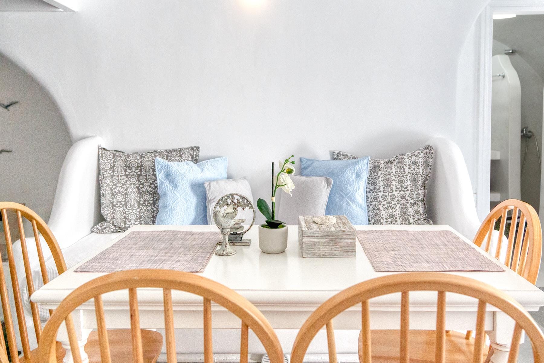 a table with a vase of flowers and a vase of flowers
