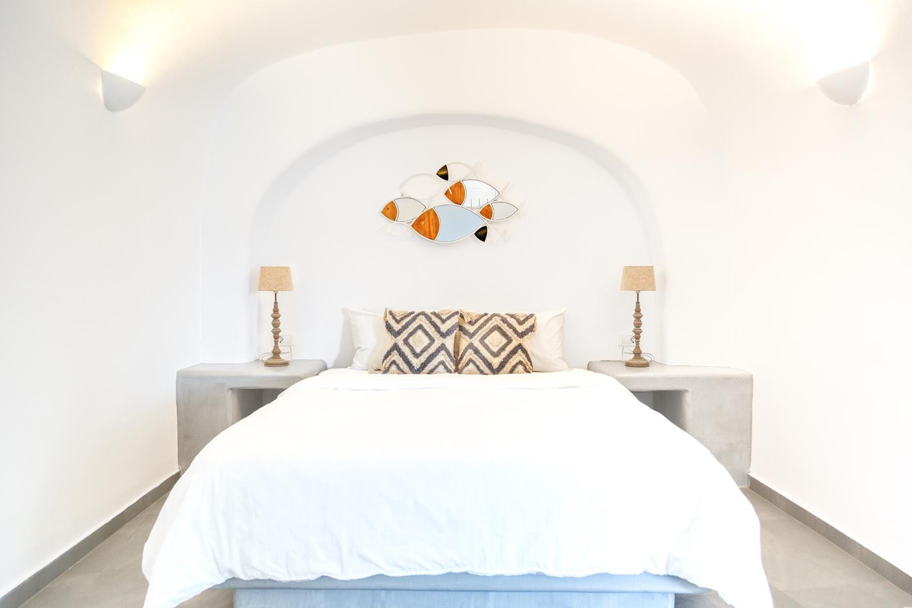 a bed with a pillow and a lamp on the side