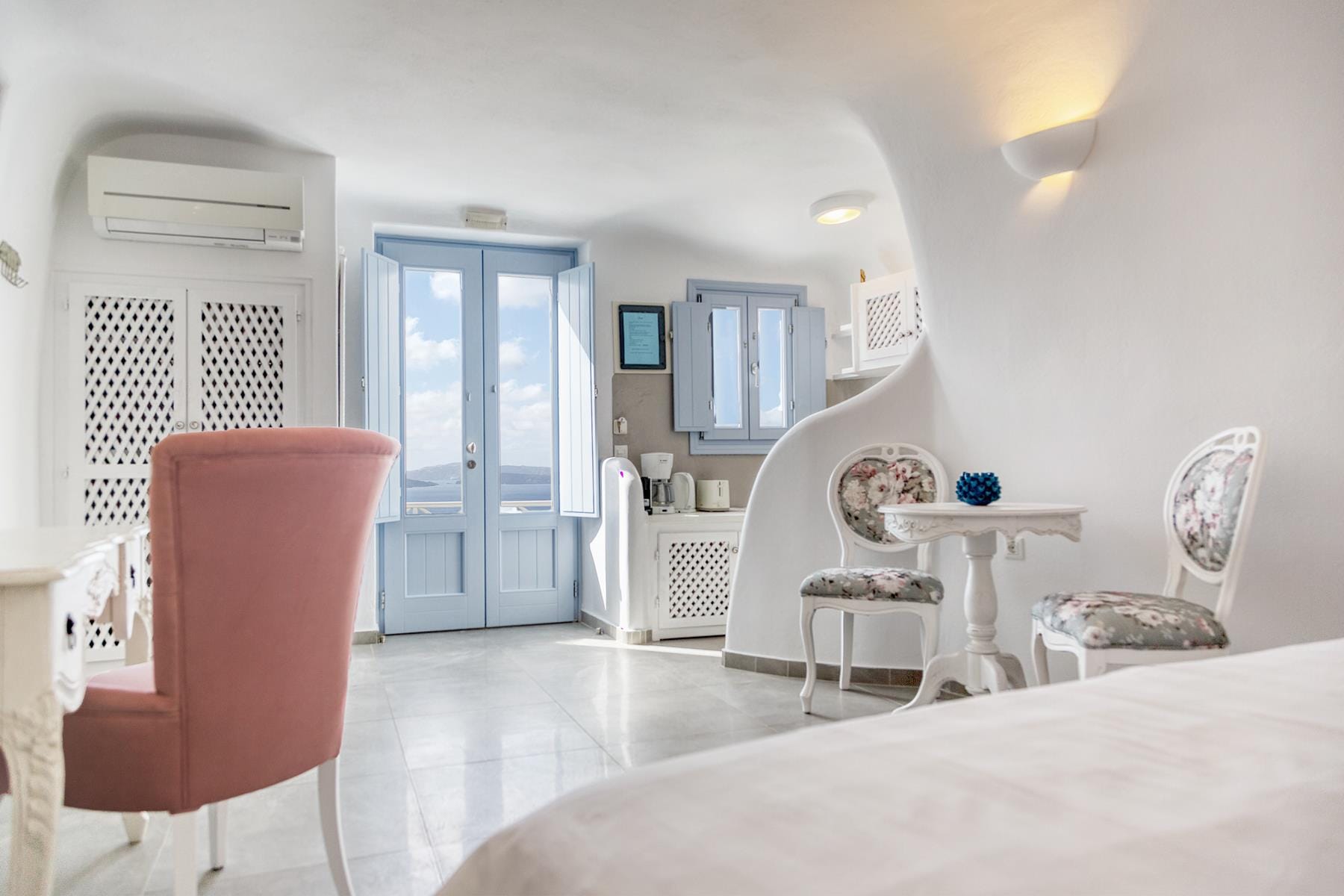 a room with a table chairs and a door