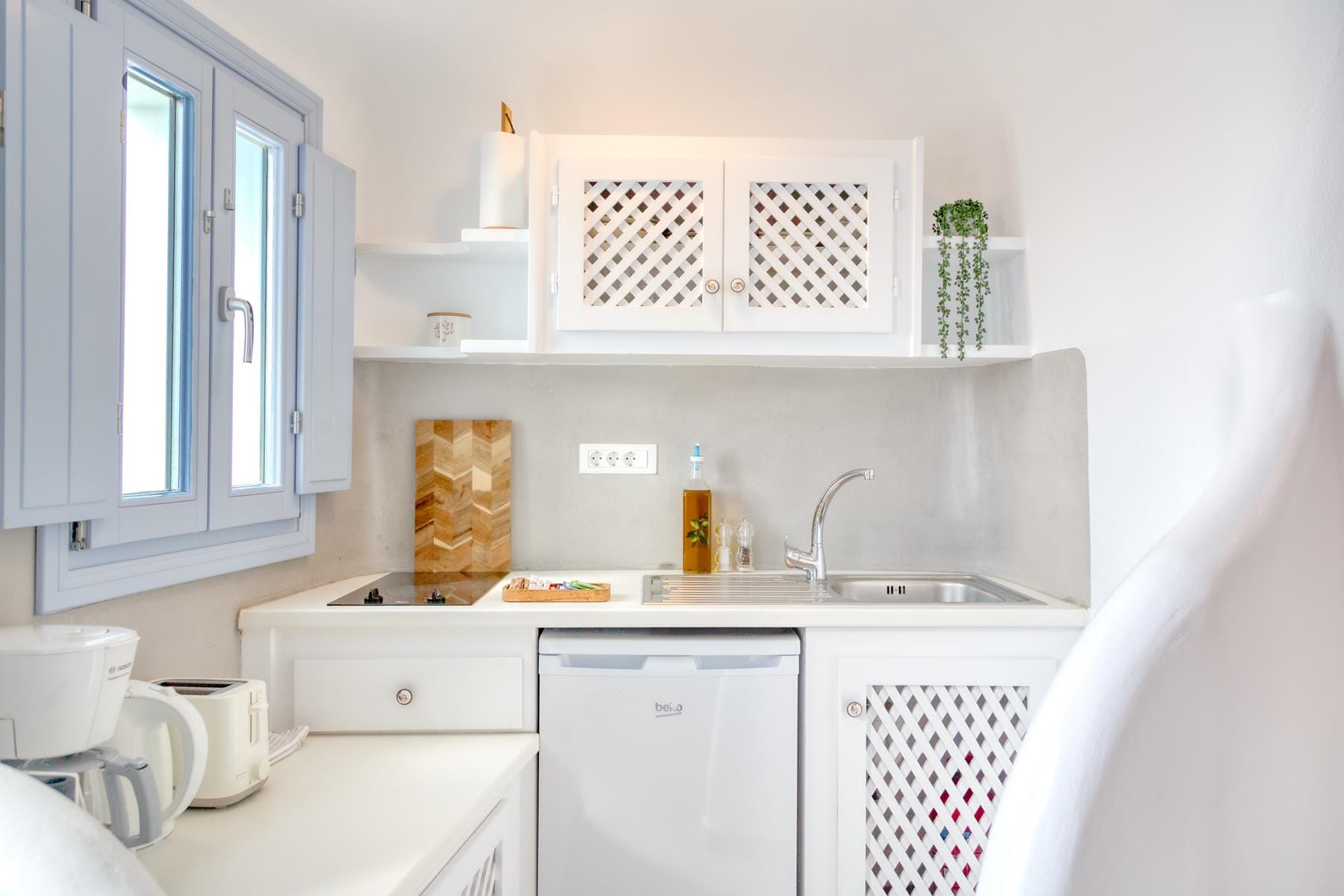 a kitchen with white cabinets